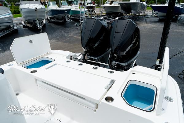 2025 Caymas 281 HB boat with dual Mercury engines, featuring storage compartments and sleek design.