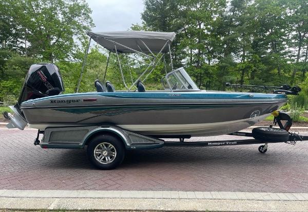 2025 Ranger 1850MS boat on trailer, parked outdoors with trees in background.