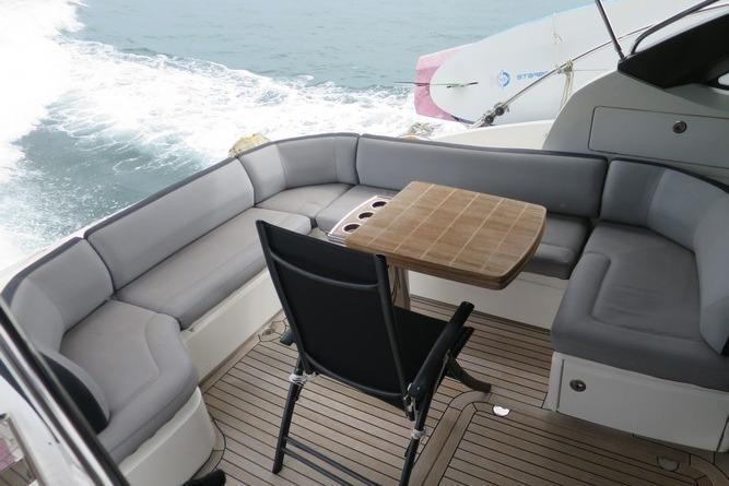 Luxurious seating area on a 2016 Princess V48 yacht with ocean view.