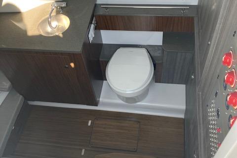 2025 Wellcraft 352 Fisherman boat bathroom with modern fixtures and wood accents.