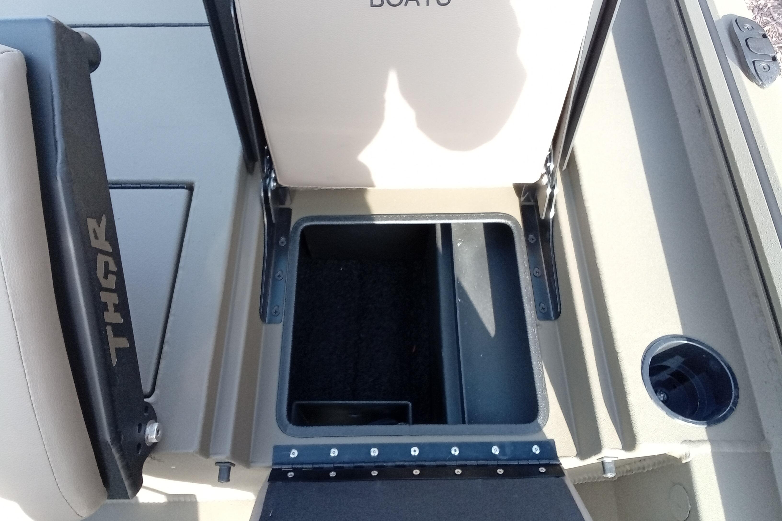 2026 Thor 1900 Low Country Elite boat storage compartment with open lid and cup holder.