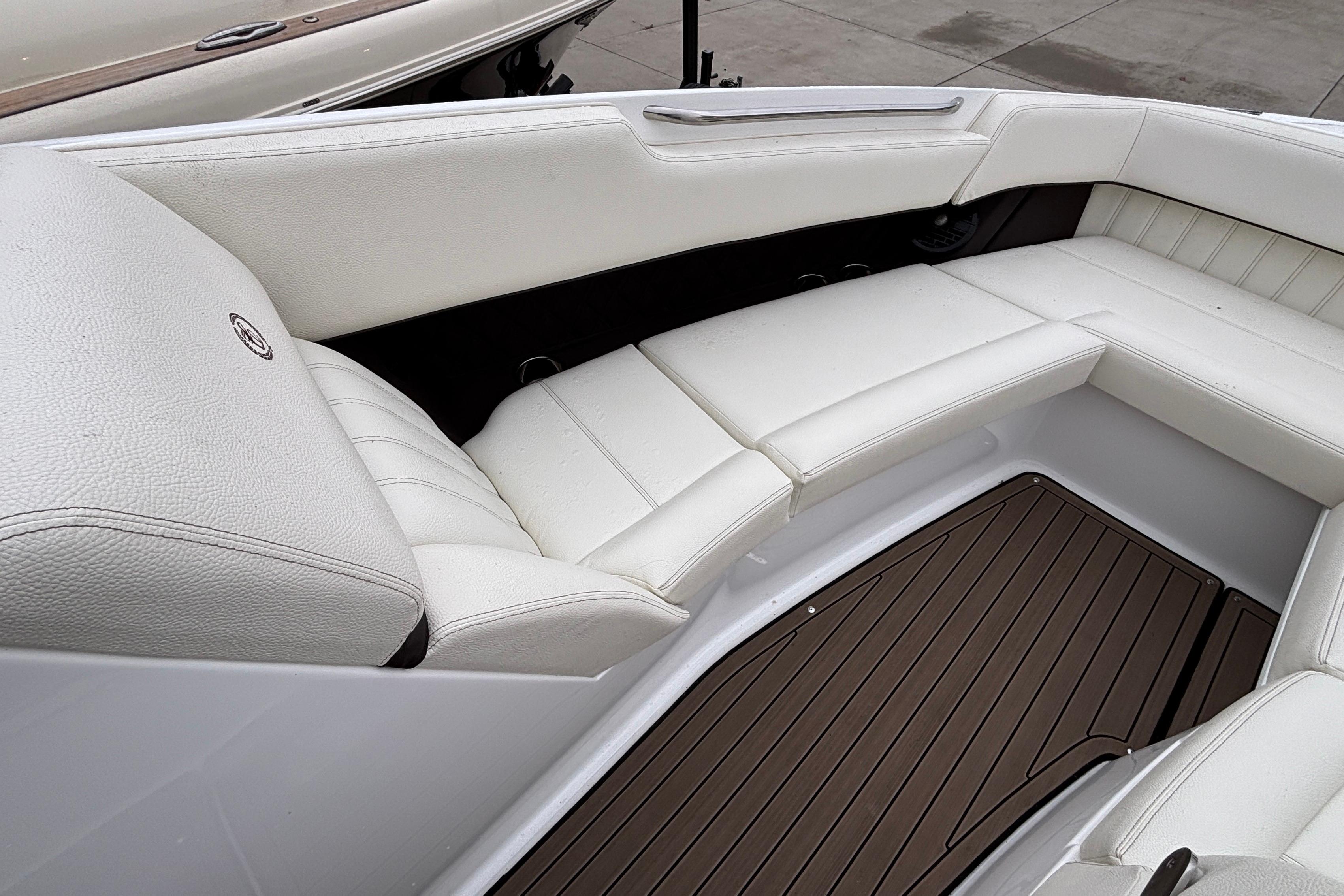 Luxurious white seating in 2022 Cobalt R35 boat, featuring elegant design and wood flooring.