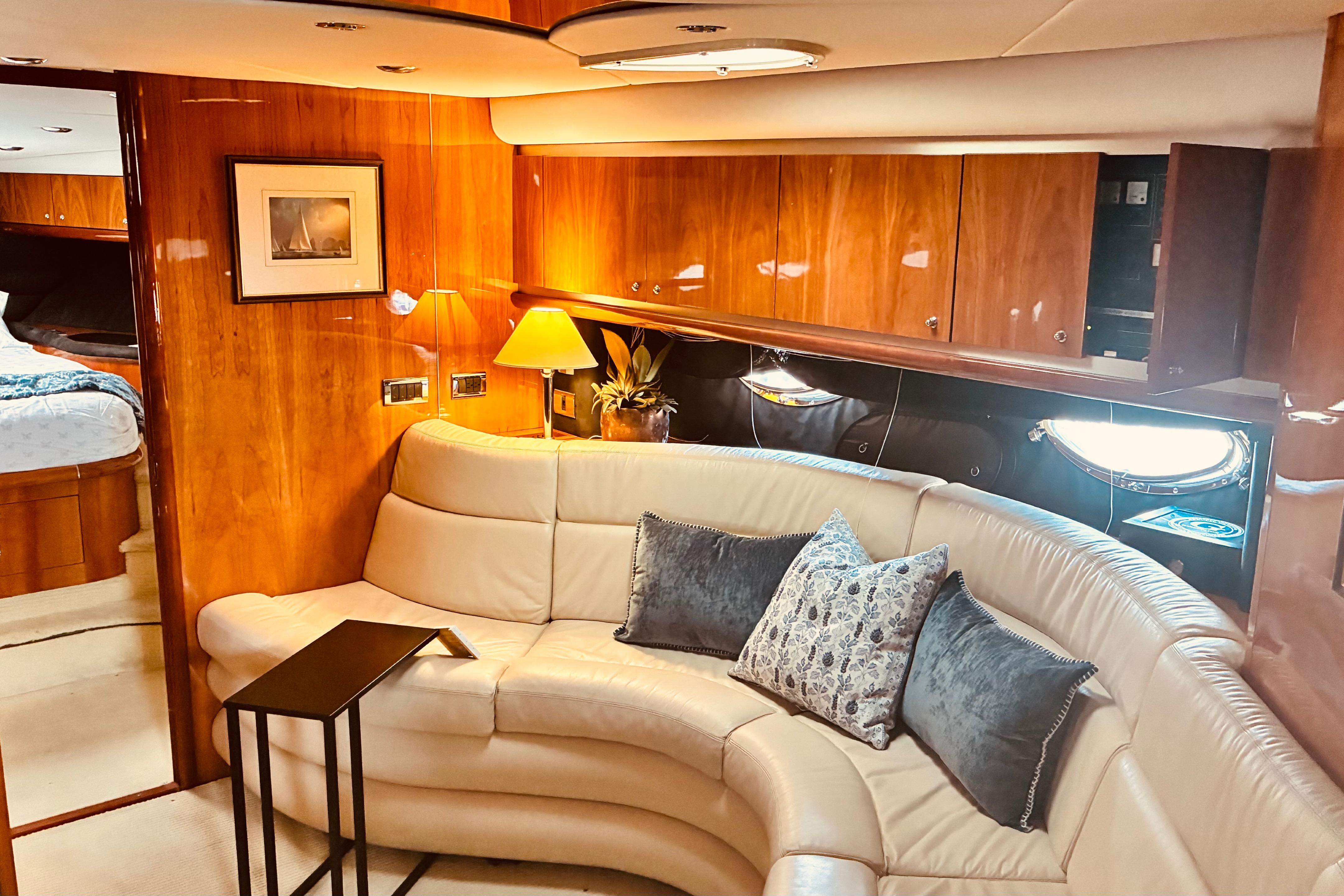 Luxurious interior of 2003 Sunseeker Predator 61 yacht with elegant seating and decor.
