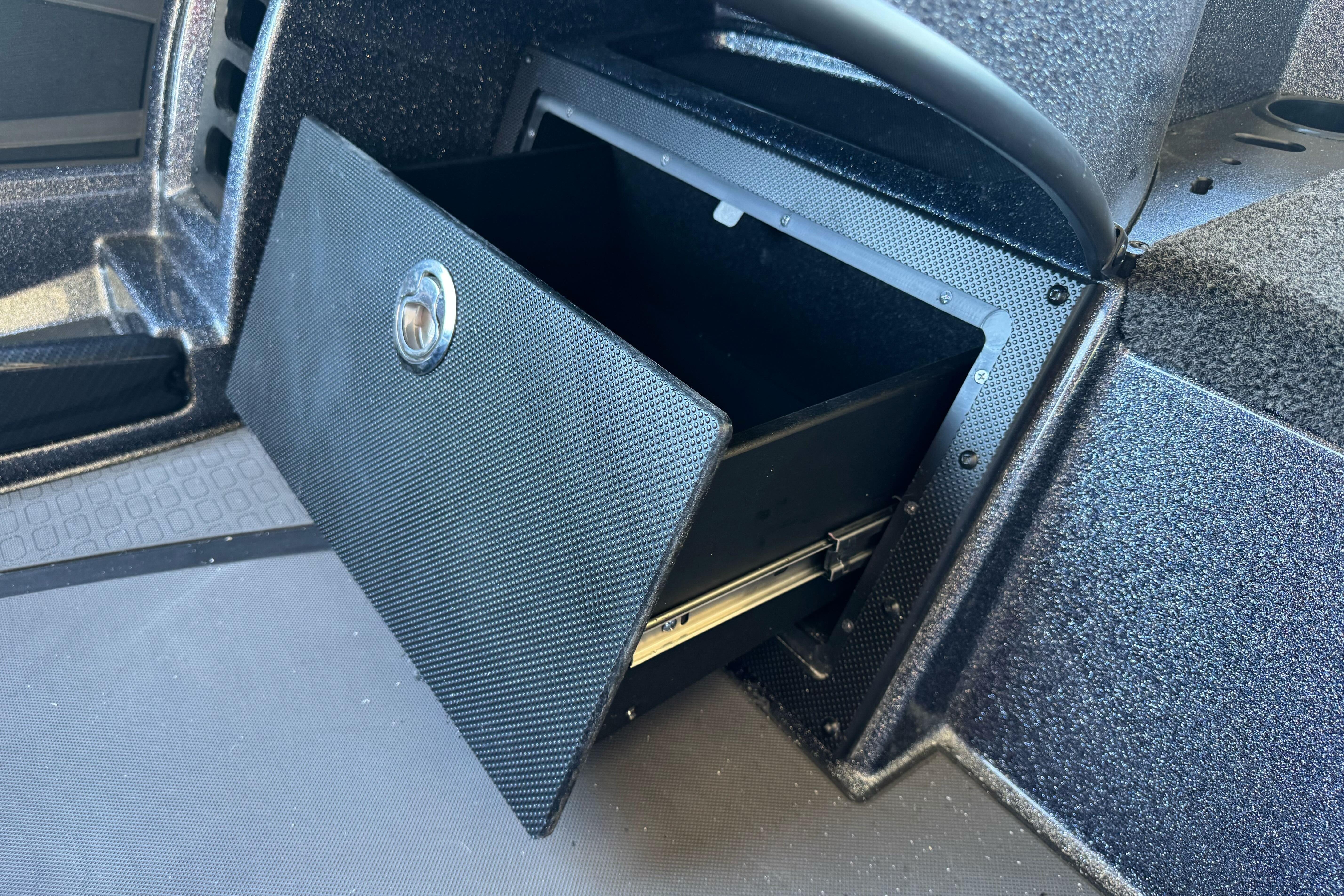 Open storage compartment in 2026 Triton 21XP Patriot boat interior.