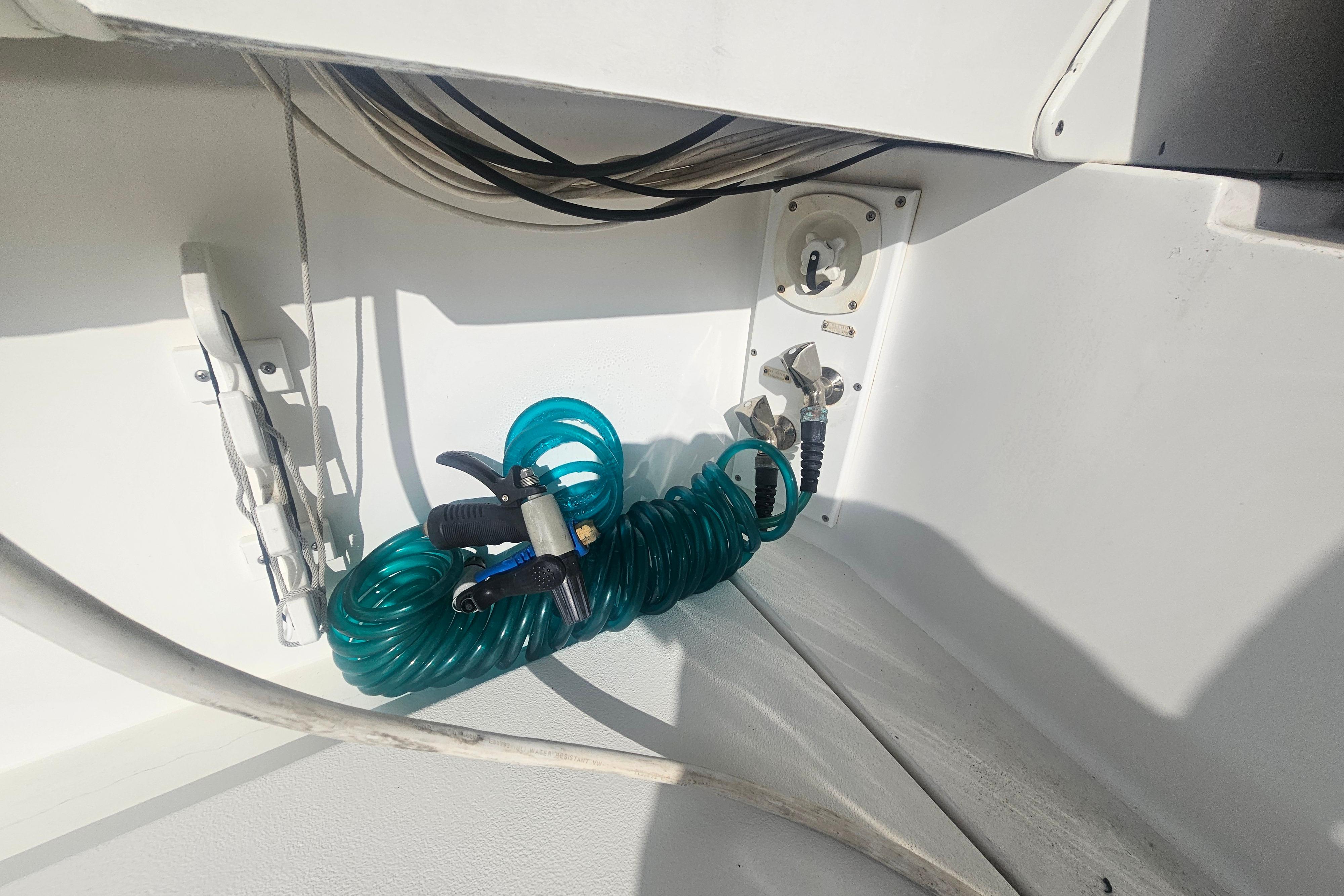 Coiled hose and fittings on 2003 Topaz 32 Express boat deck.