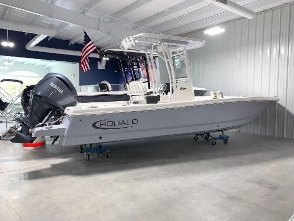 2024 Robalo 246 Cayman boat in showroom with Yamaha outboard motor.