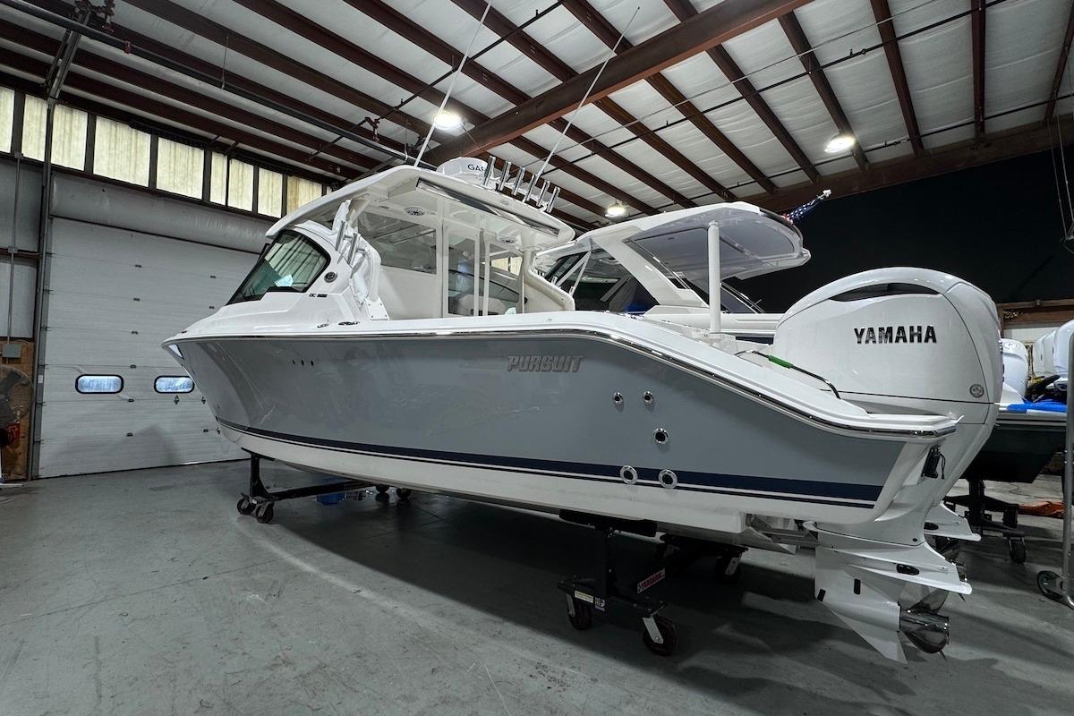 2026 Pursuit DC 326 Dual Console boat in a warehouse, featuring Yamaha engines.