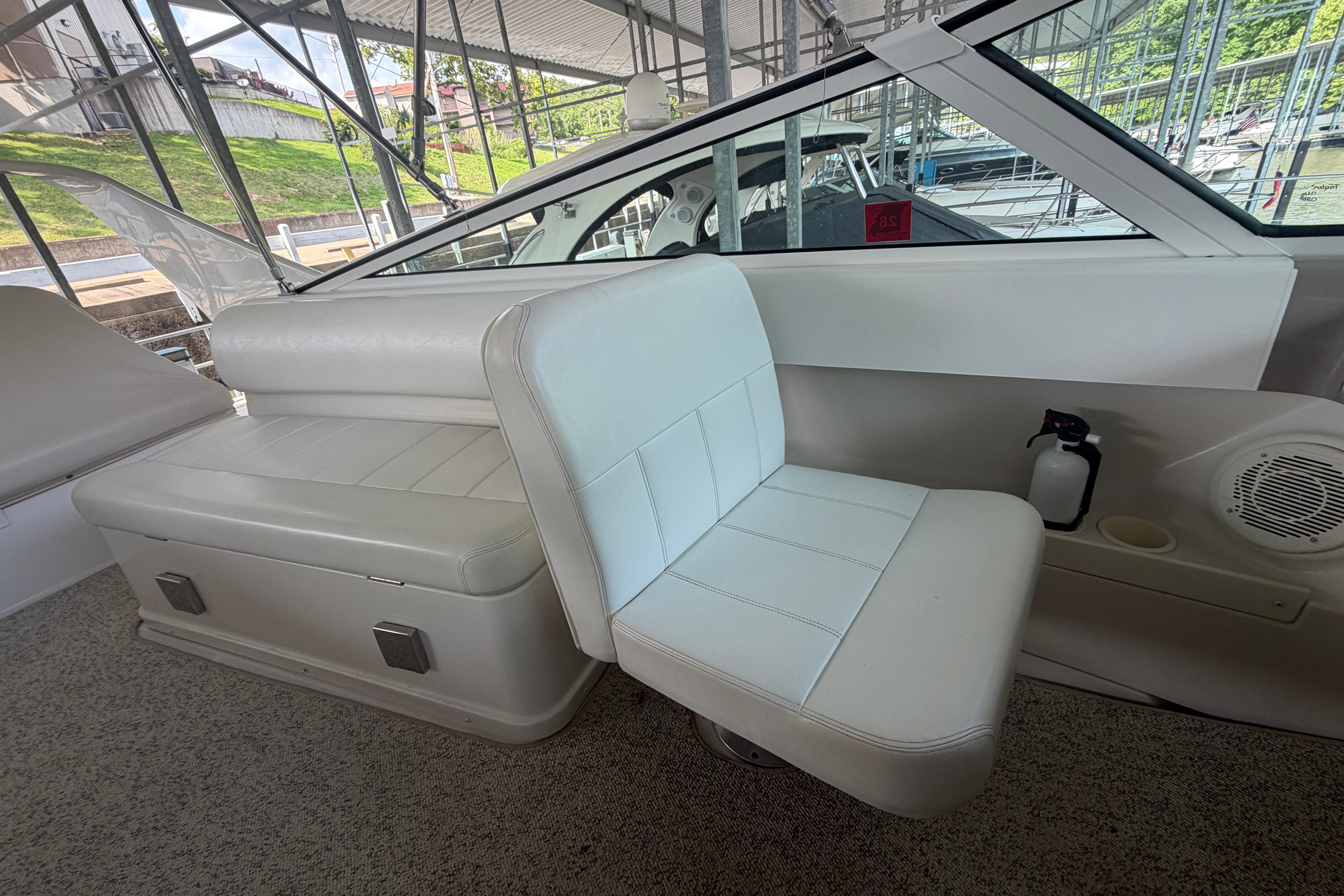 Interior seating of a 2000 Carver 350 Mariner boat with white upholstery.