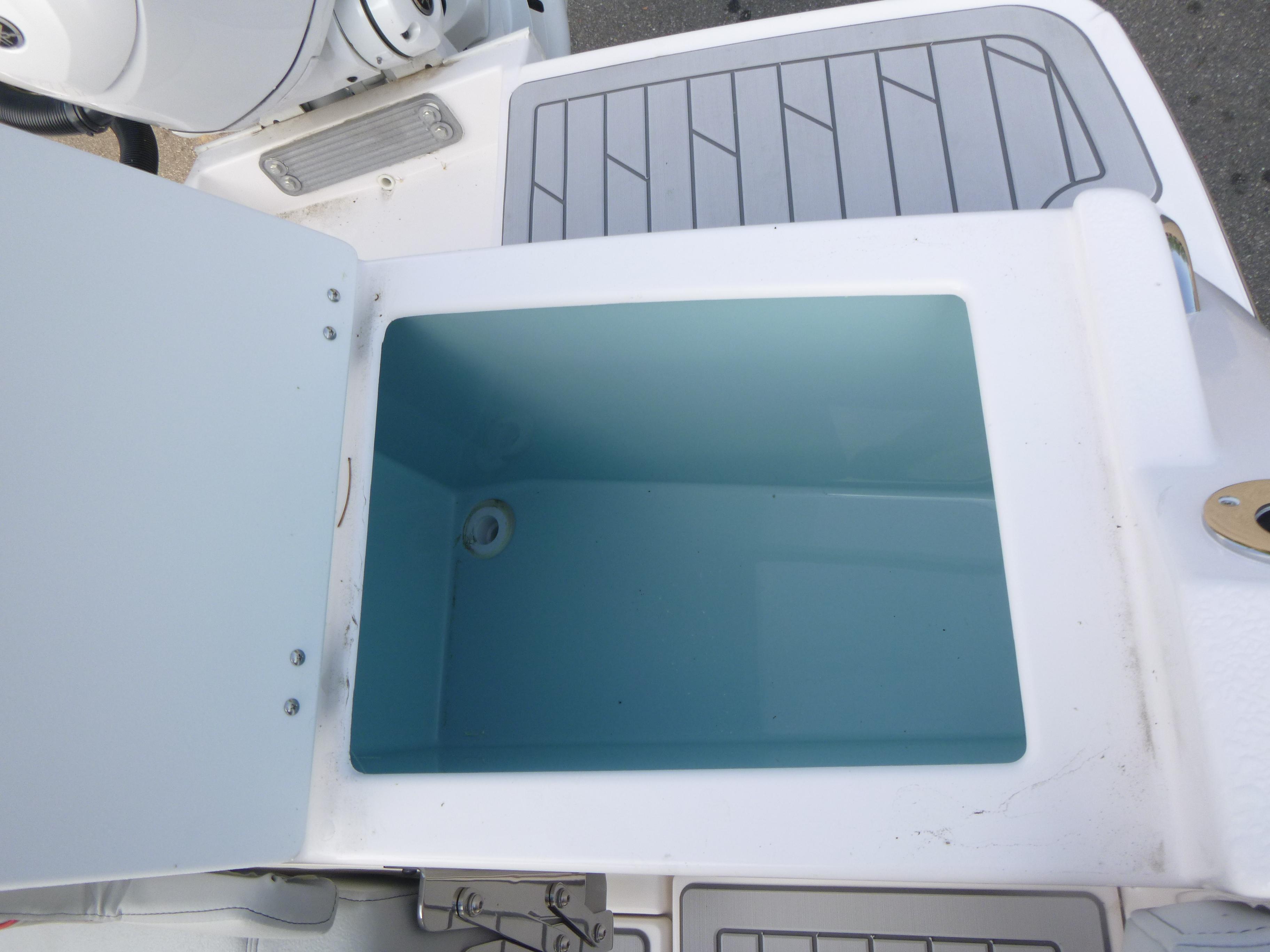 Open storage compartment on 2025 Solara S-250 CW boat, featuring a clean, spacious interior.