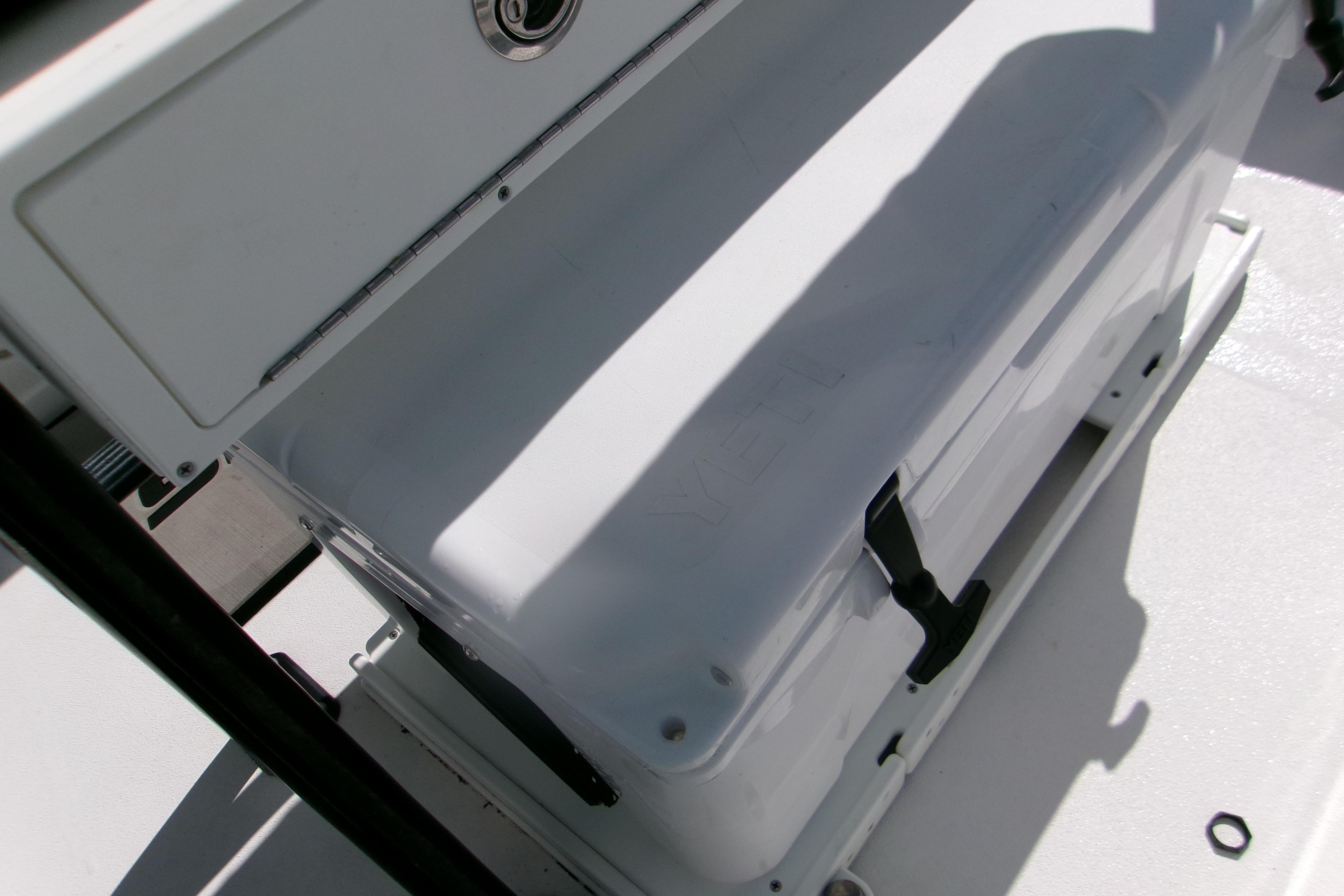 2024 Sportsman Masters 227 Bay Boat cooler storage area with secure latch.