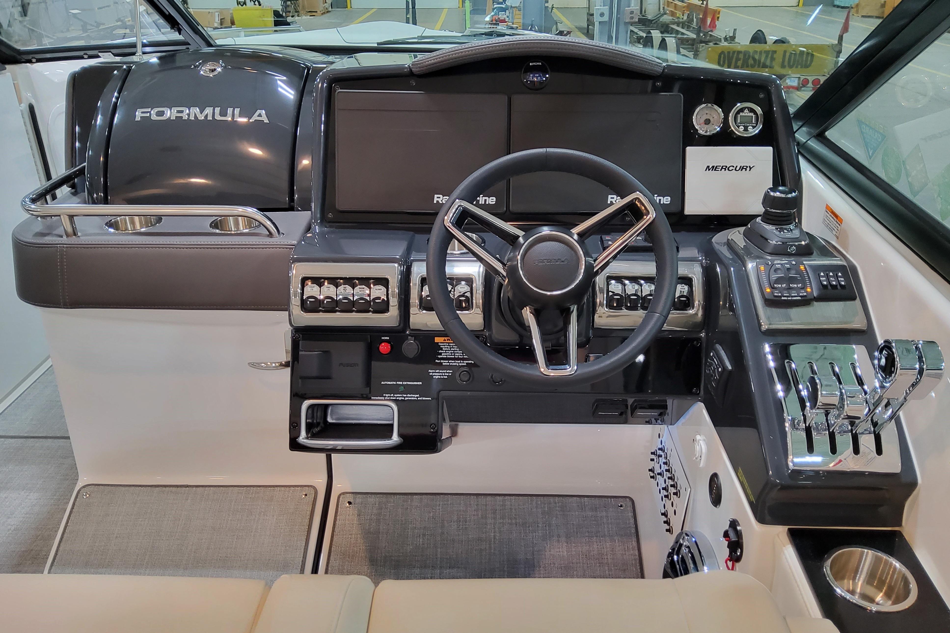 2027 Formula 350 Crossover Bowrider I/O dashboard with steering wheel and control panel.