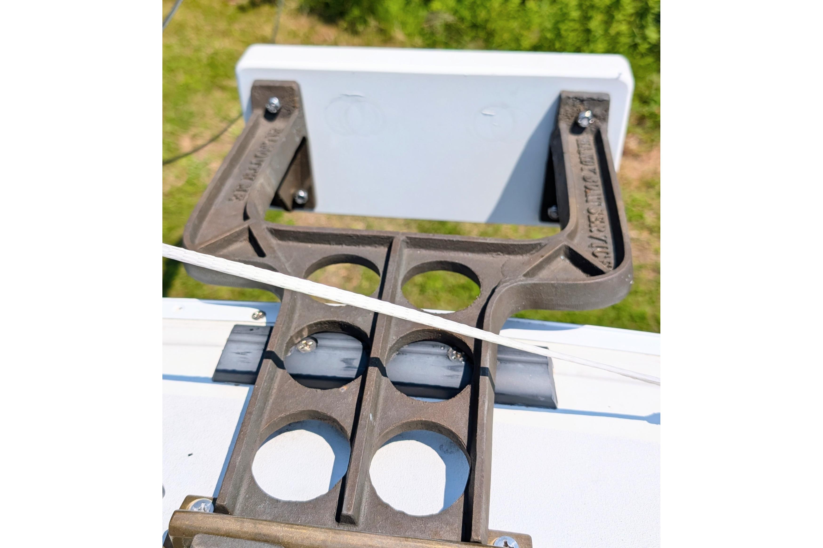 Close-up of a 1965 Pearson Ensign boat component with circular cutouts and bolts.