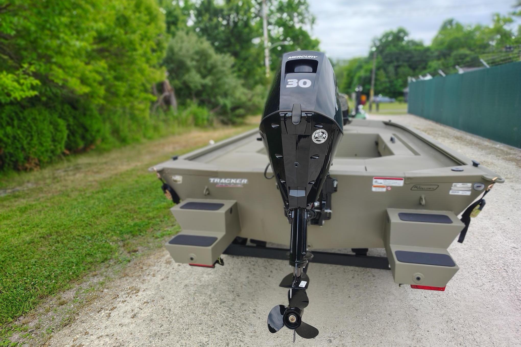 2026 Tracker Grizzly 1654 T Sportsman boat with Mercury 30 engine, parked outdoors.