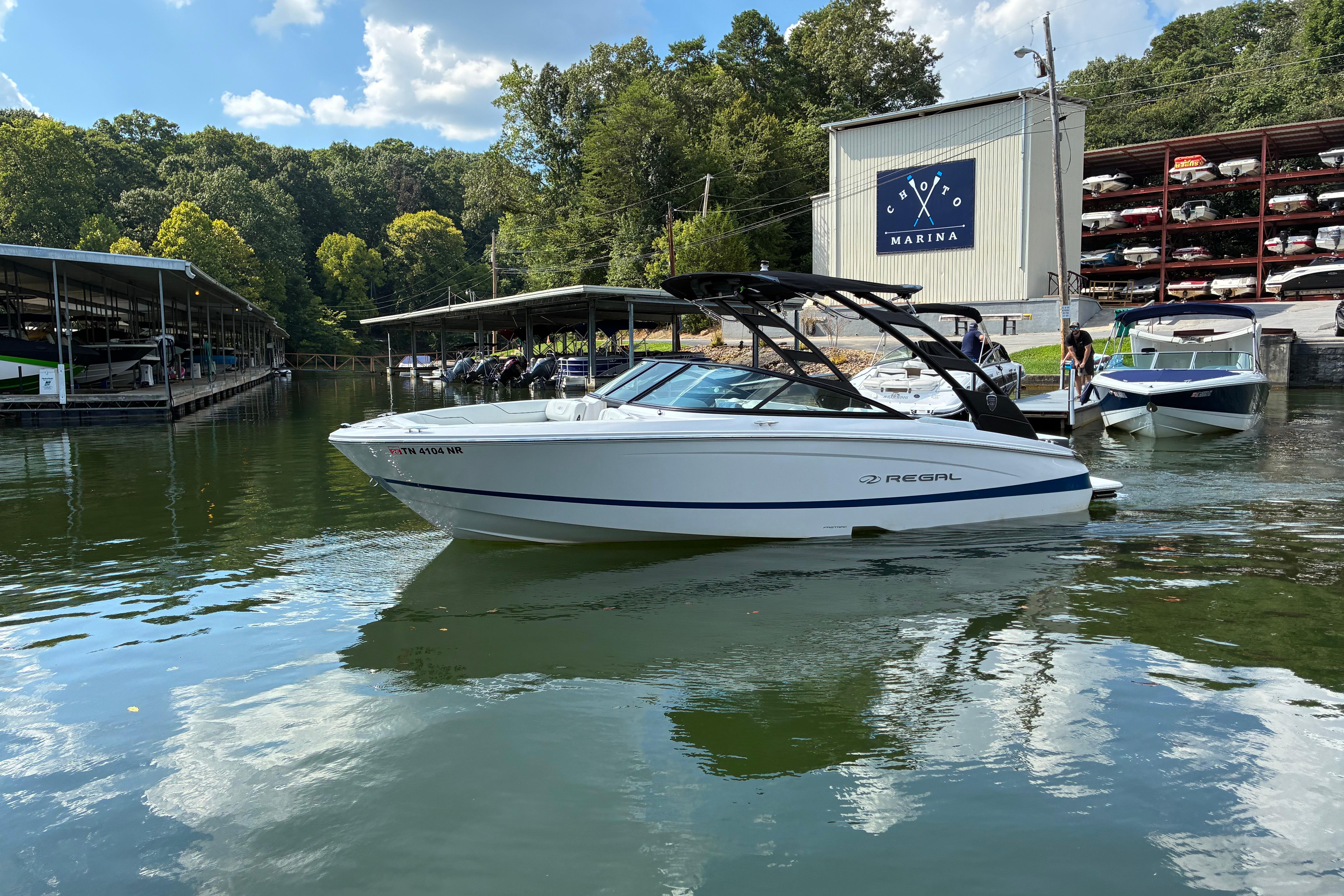 2025 Regal LS2 boat docked at Choto Marina, surrounded by lush greenery.