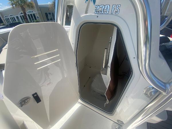 2024 Key West 239 FS boat storage compartment with open hatch.