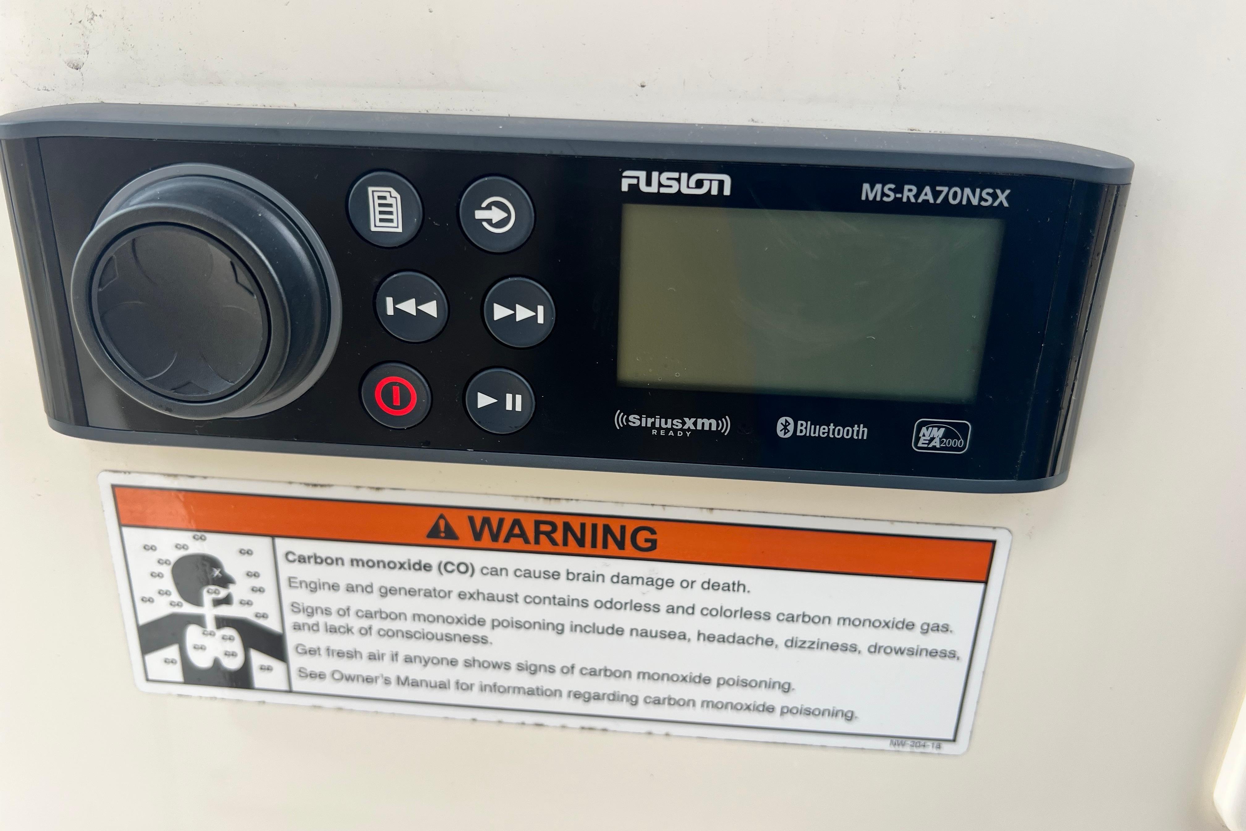 Fusion MS-RA70NSX stereo system on 2020 Scout 195 Sportfish with carbon monoxide warning label.