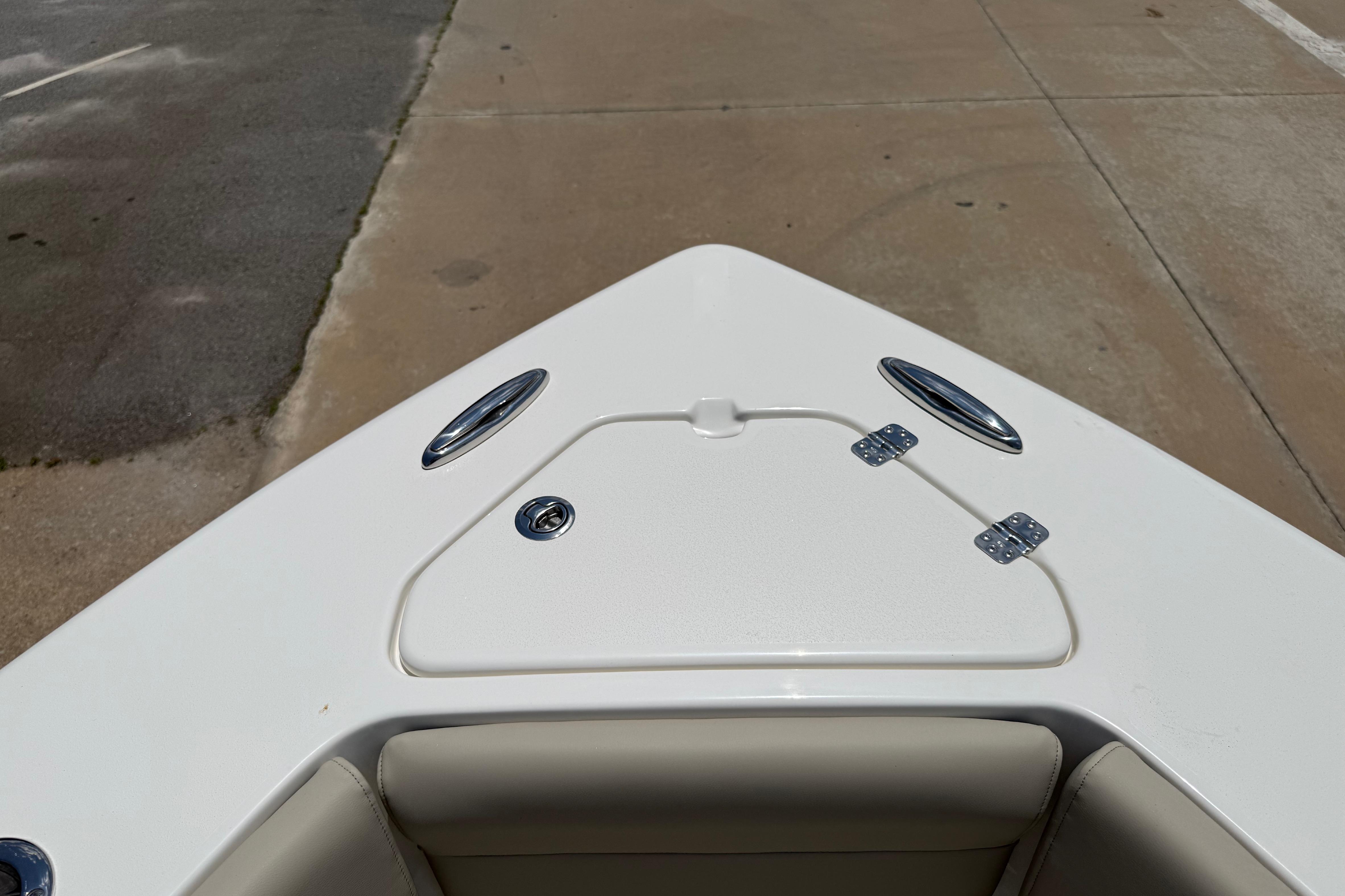 Bow of 2027 Key West 249 FS boat with storage compartment and cleats.