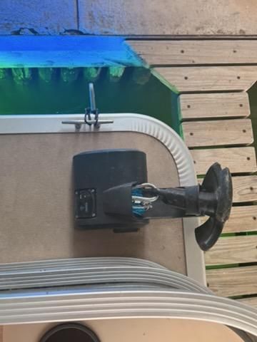 Close-up of a boat steering wheel and part of the deck.