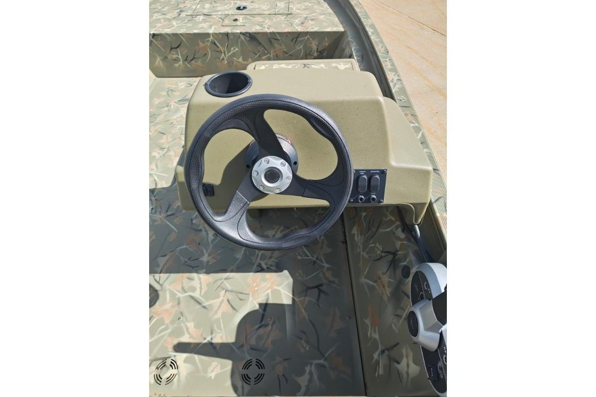 Steering console of 2025 Tracker Grizzly 1648 SC boat with camouflage design.