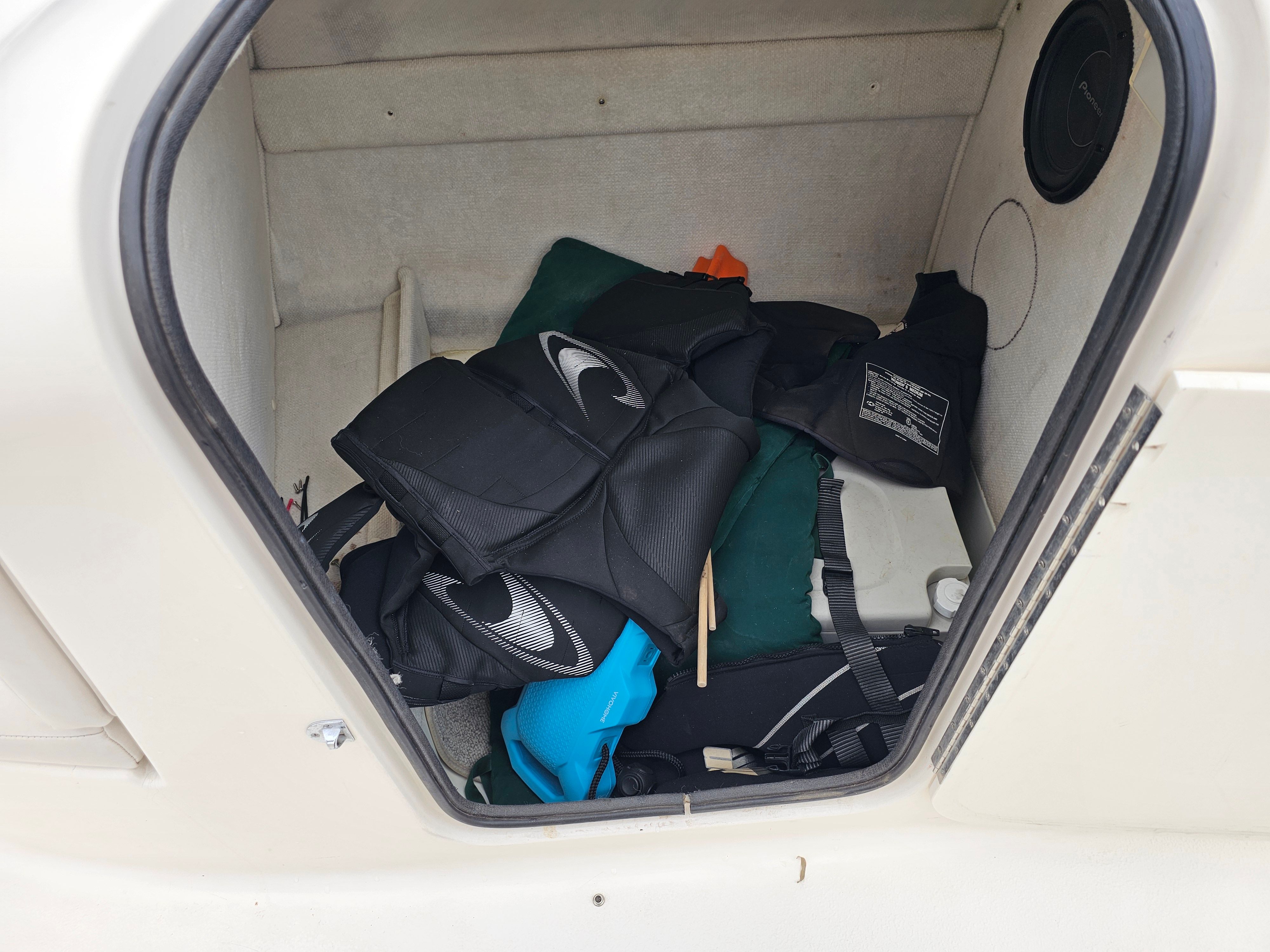 Storage compartment in Chaparral Sunesta 252 with life jackets, 1998 model.