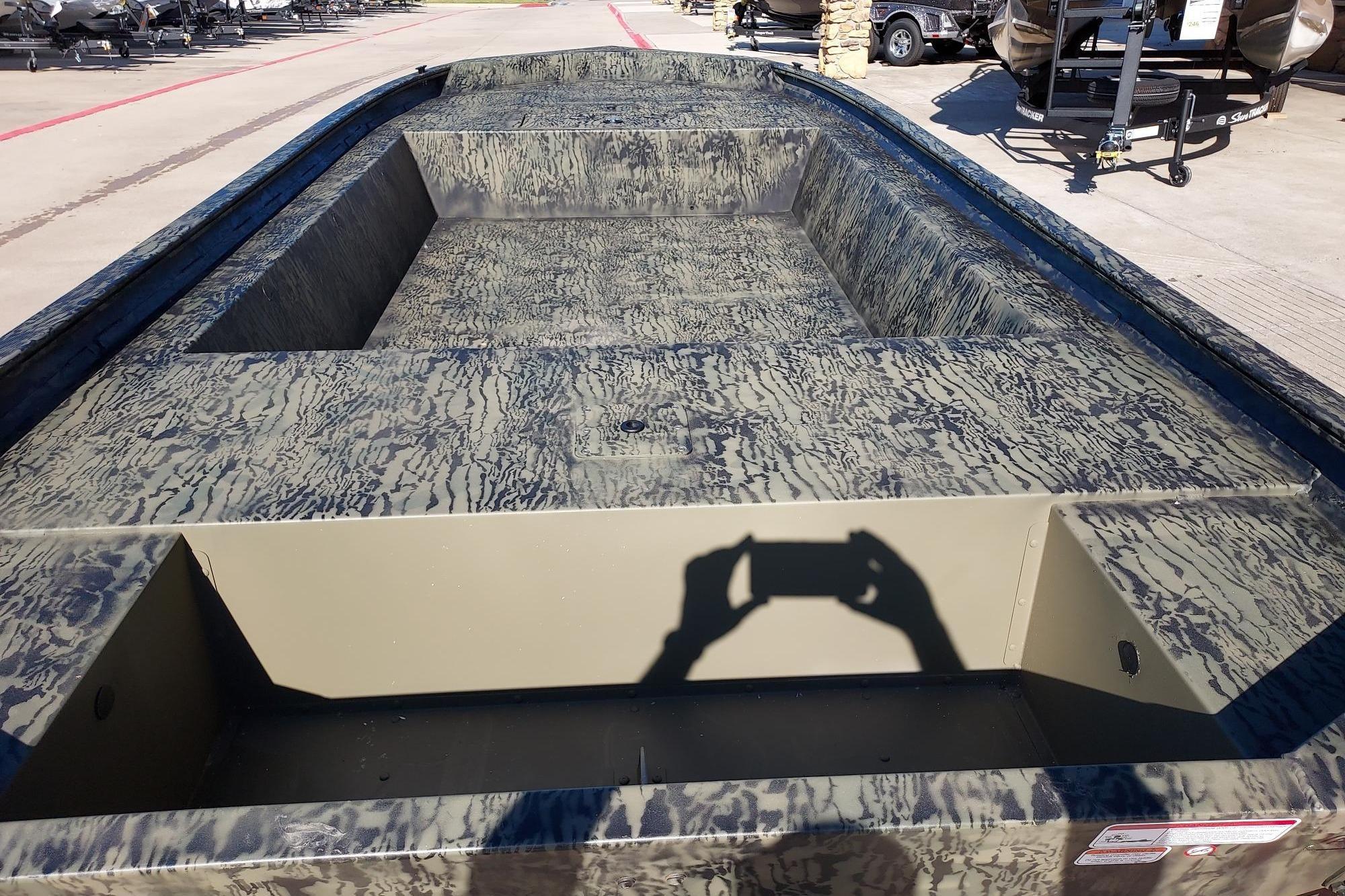 2026 Tracker Grizzly 1754 Utility boat with camouflage pattern, displayed outdoors.