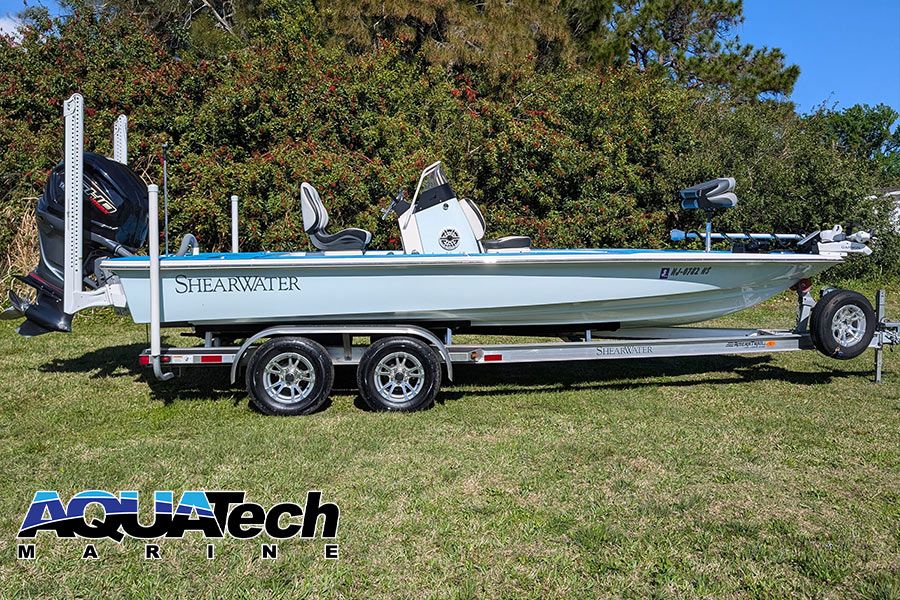 ShearWater x22 boat on a trailer on grass.