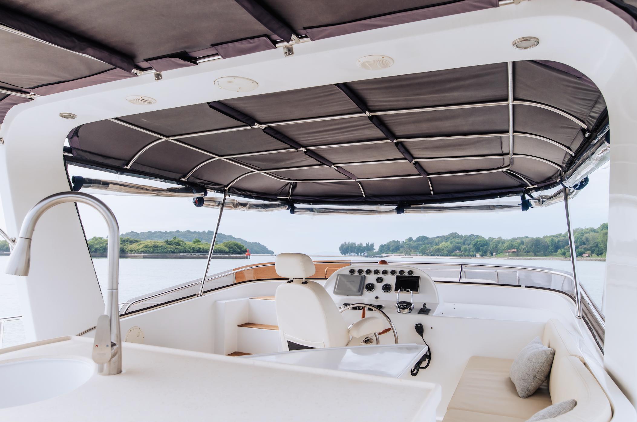 Flybridge of 2011 SeaStella Trawler 53ft with helm, seating, and canopy.