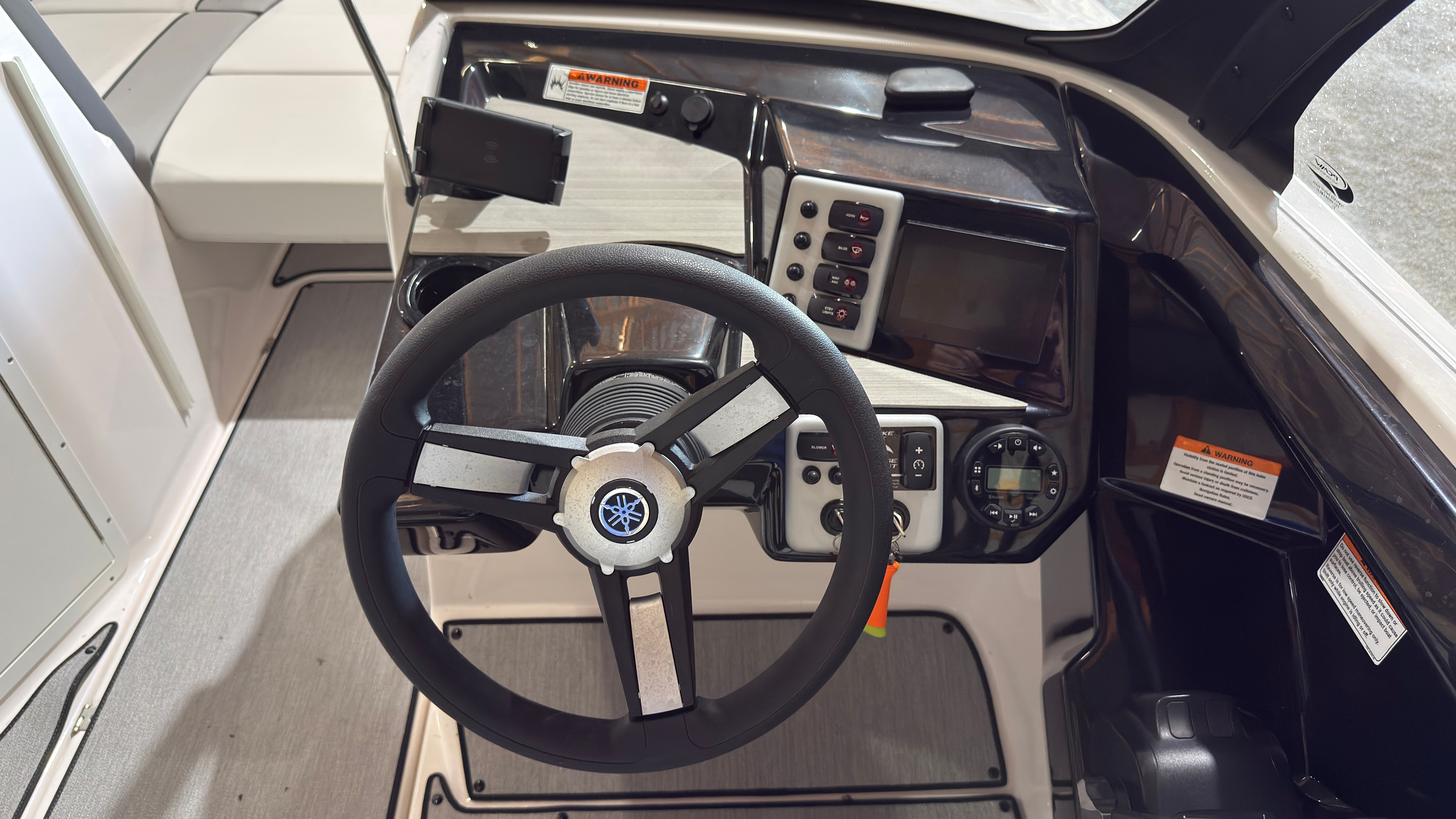 Yamaha Boats AR220 2024 helm with steering wheel and controls.