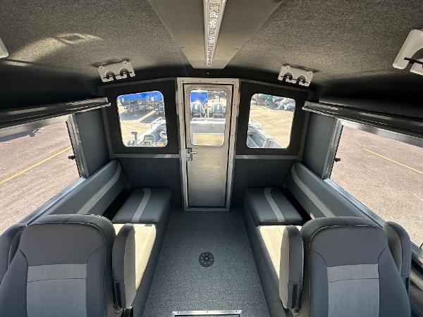 Interior of 2024 Spartan 260 Maximus Pro XL boat with seating and windows.