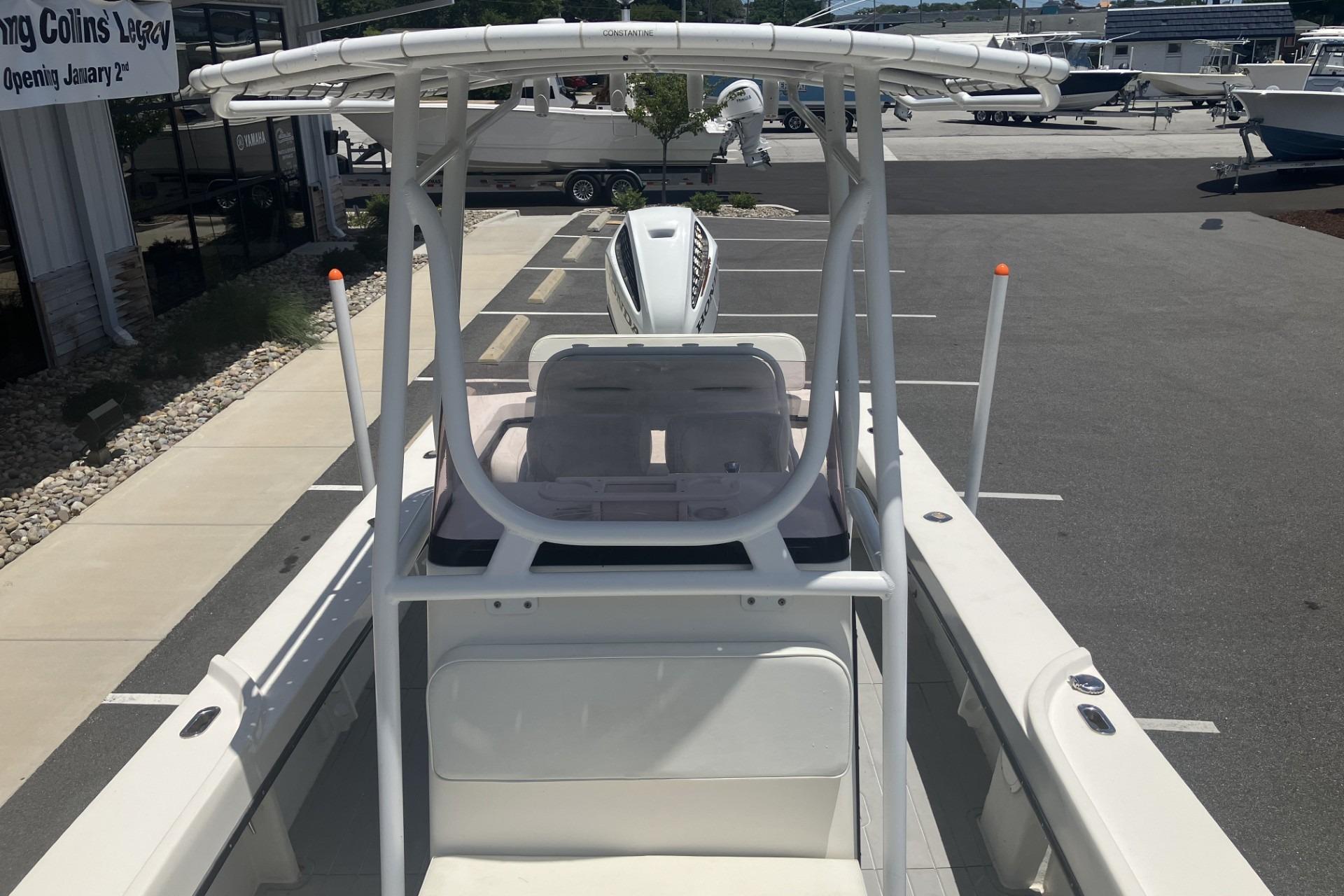 2022 May-Craft 2300 CCX boat with T-top in a parking lot.