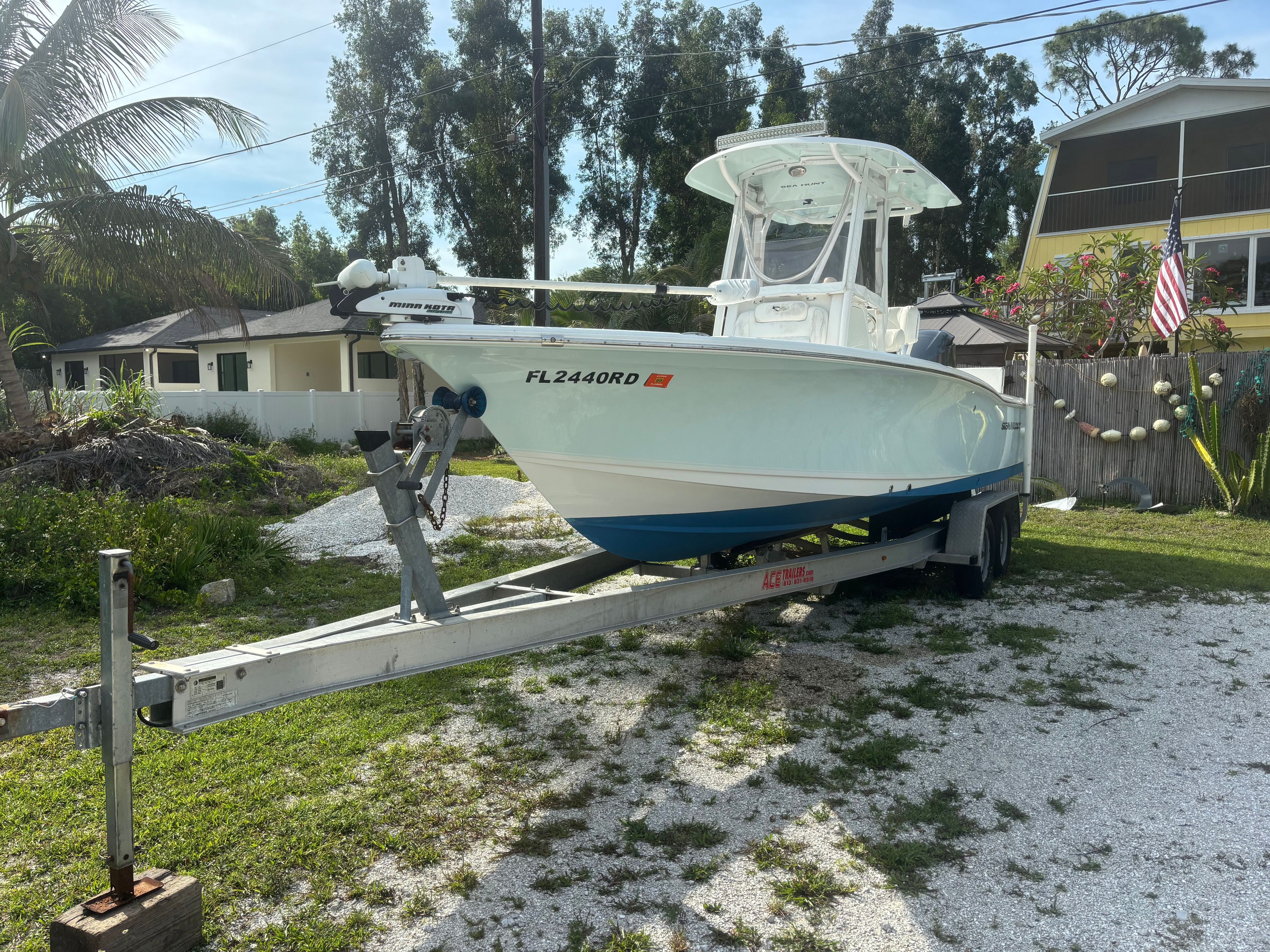 A 2016 Sea Hunt BX 24 BR boat on a trailer in a residential area.