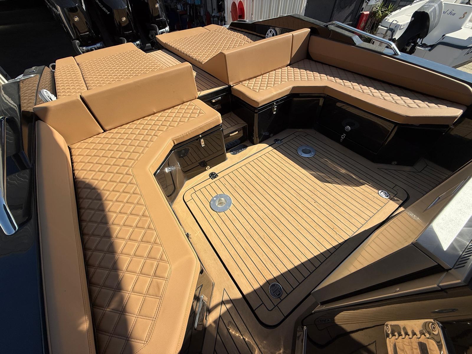 Luxurious 2024 SPX RIB 38 boat interior with tan quilted seating and spacious deck.