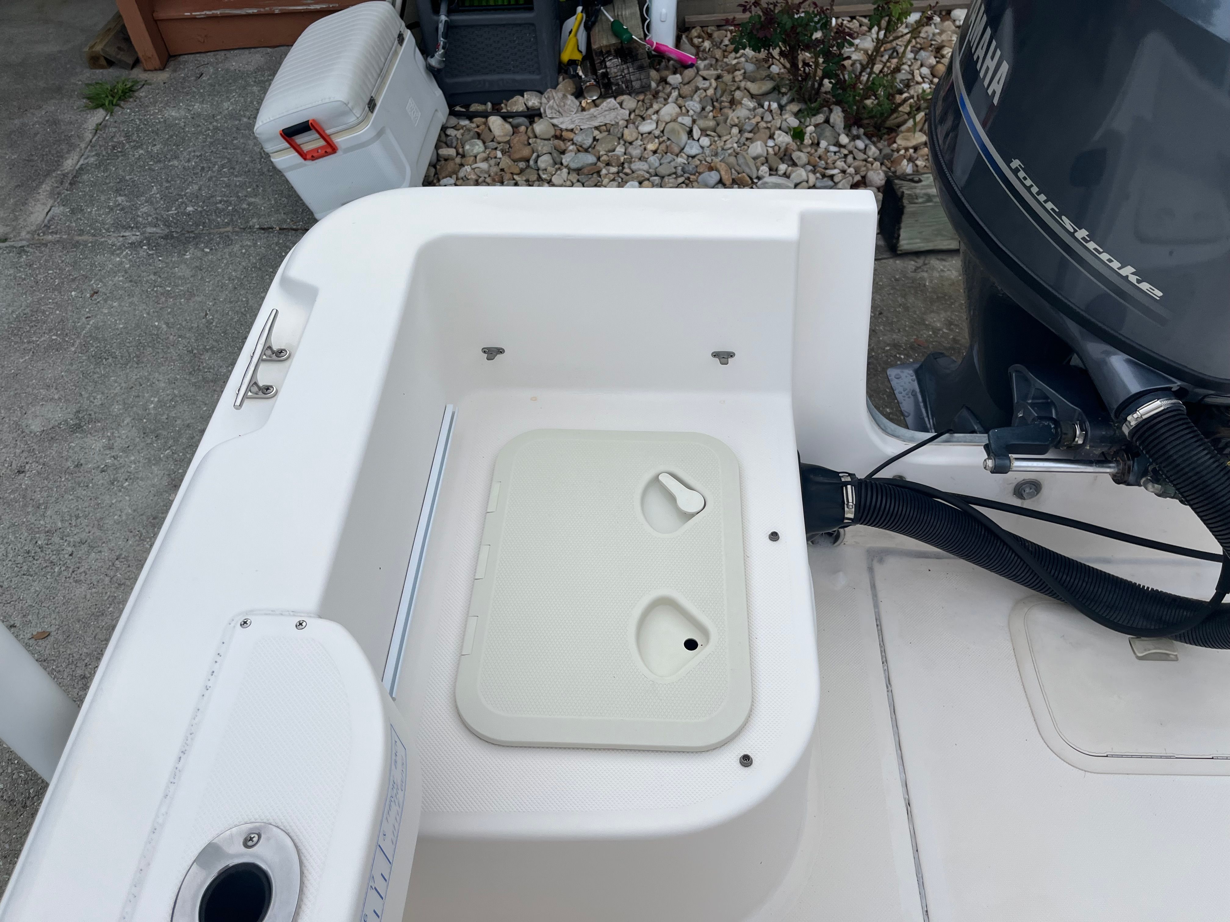 A boat with a Yamaha motor and storage area in the stern.