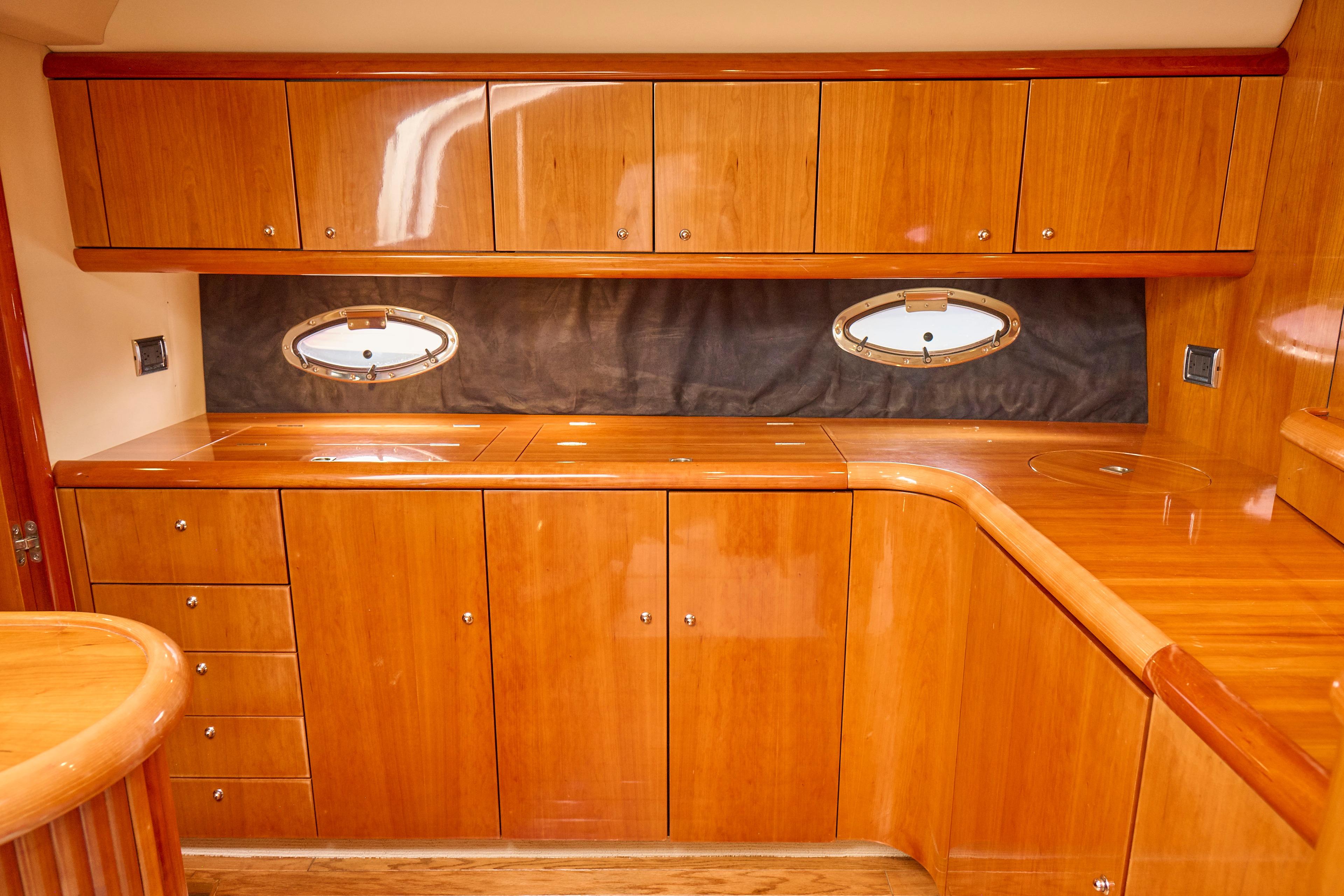 Luxurious wooden interior of 2000 Sunseeker Camargue 50 yacht kitchen.