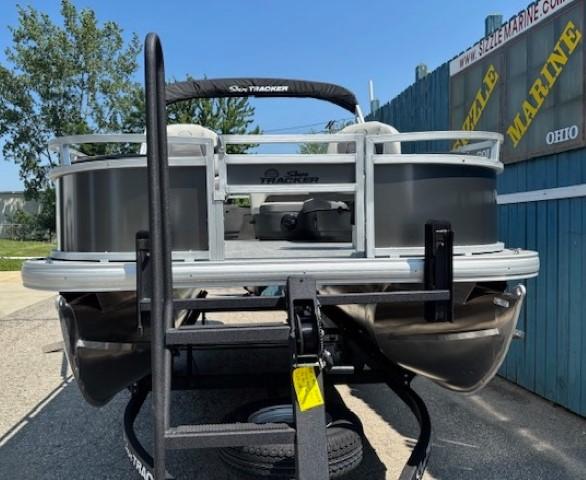 2026 Sun Tracker Bass Buggy 18 DLX pontoon boat on trailer, outdoor display.