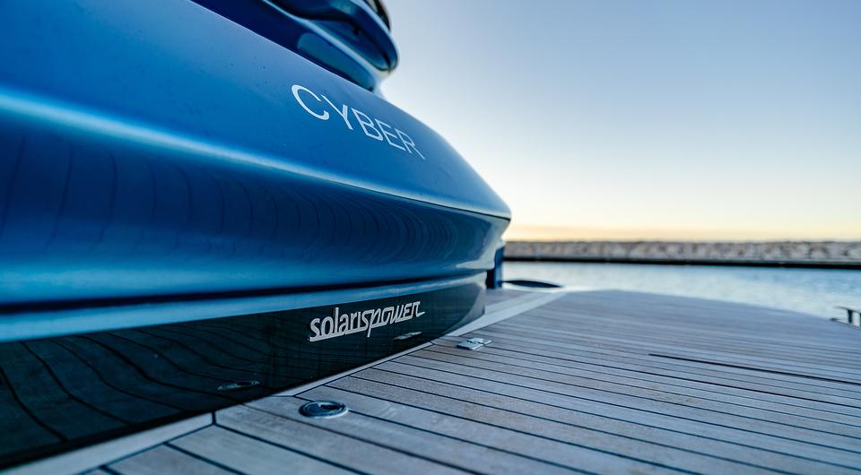 2024 Solaris Power 60 Open yacht docked, showcasing sleek blue design and branding.