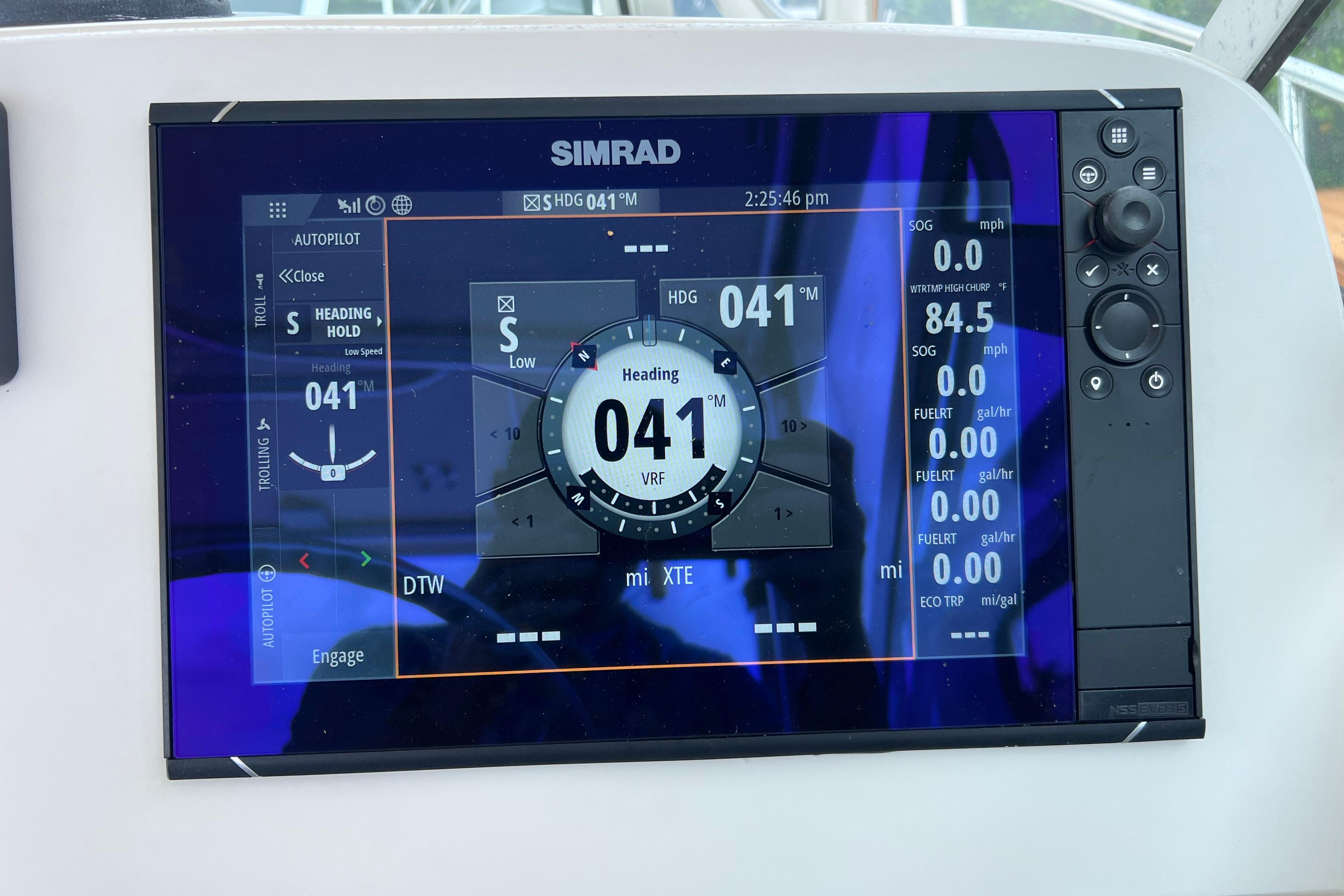 Simrad navigation display on 2005 Pursuit 3070 Offshore boat, showing heading and speed data.