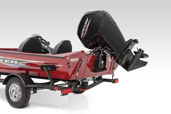 Red Tracker boat with a powerful outboard motor, mounted on a trailer.