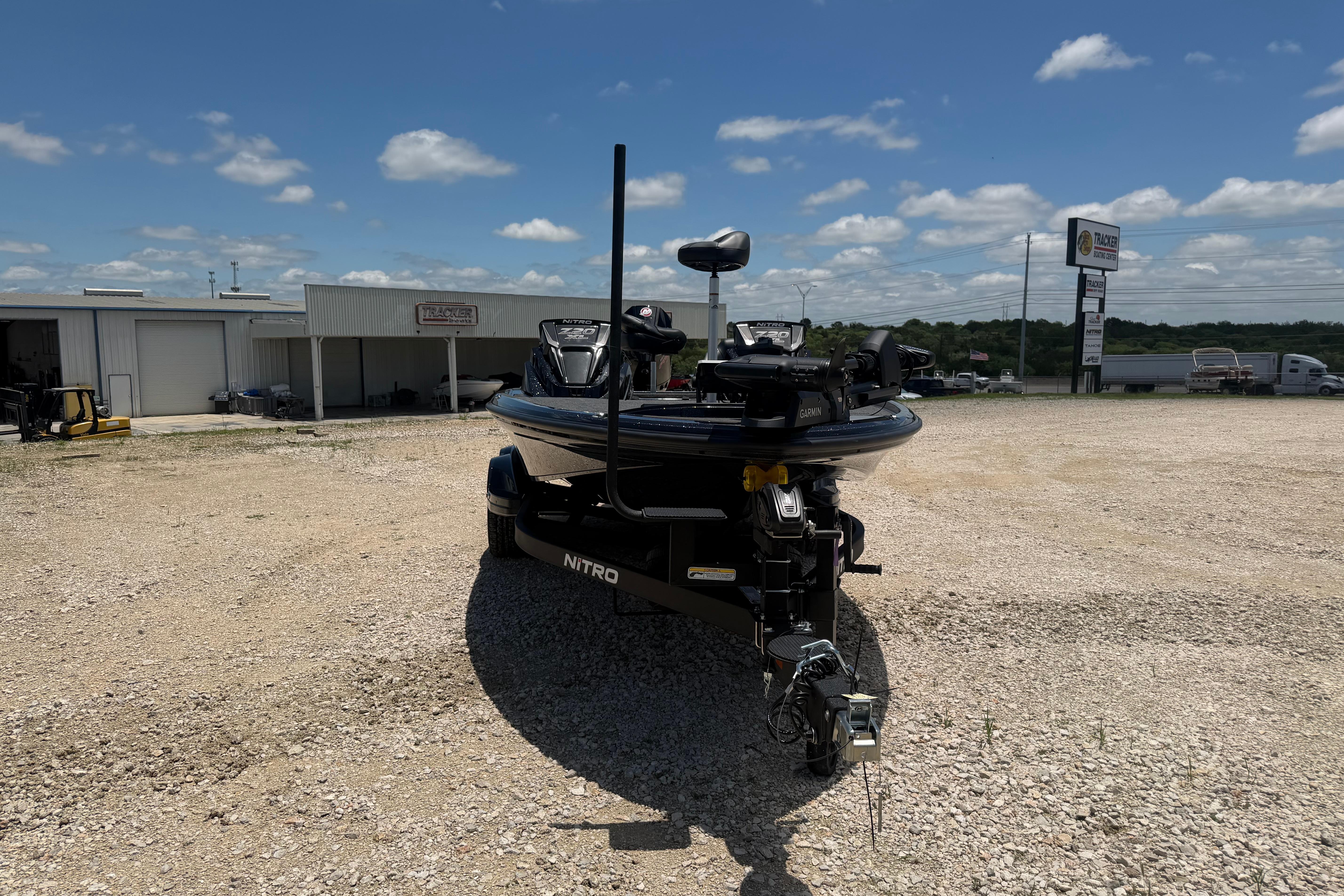 2026 Nitro Z20 XL Pro boat on trailer in gravel lot under blue sky.