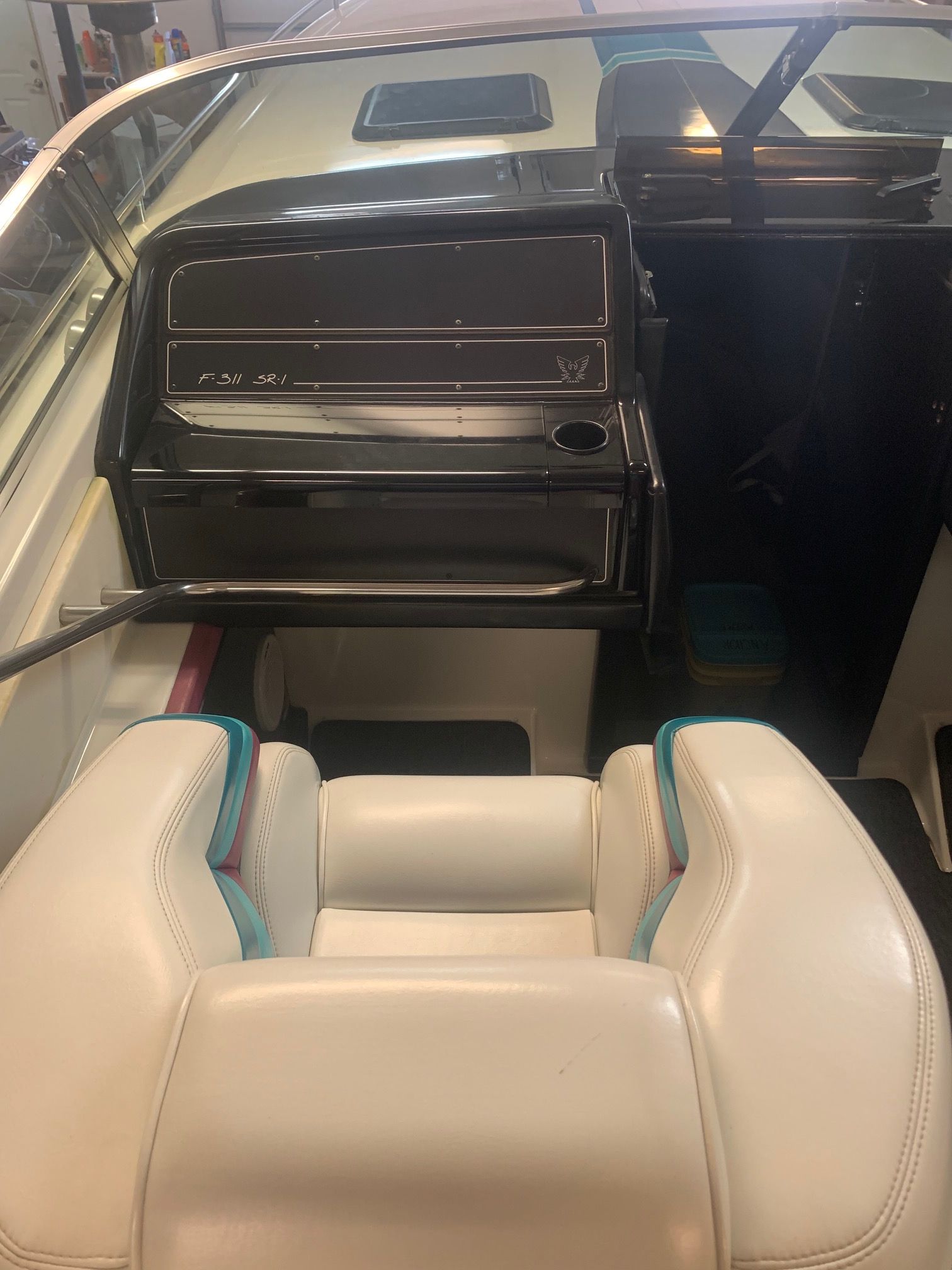 Interior view of a 1988 Formula 311 SR1 with white seats and a black dashboard.