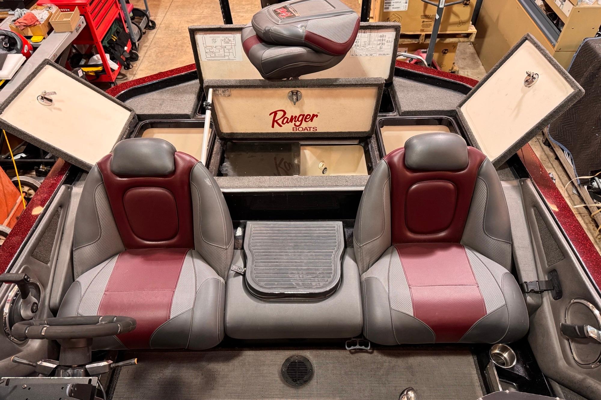 2017 Ranger Z520 Comanche boat interior with red and gray seats, open storage compartments.