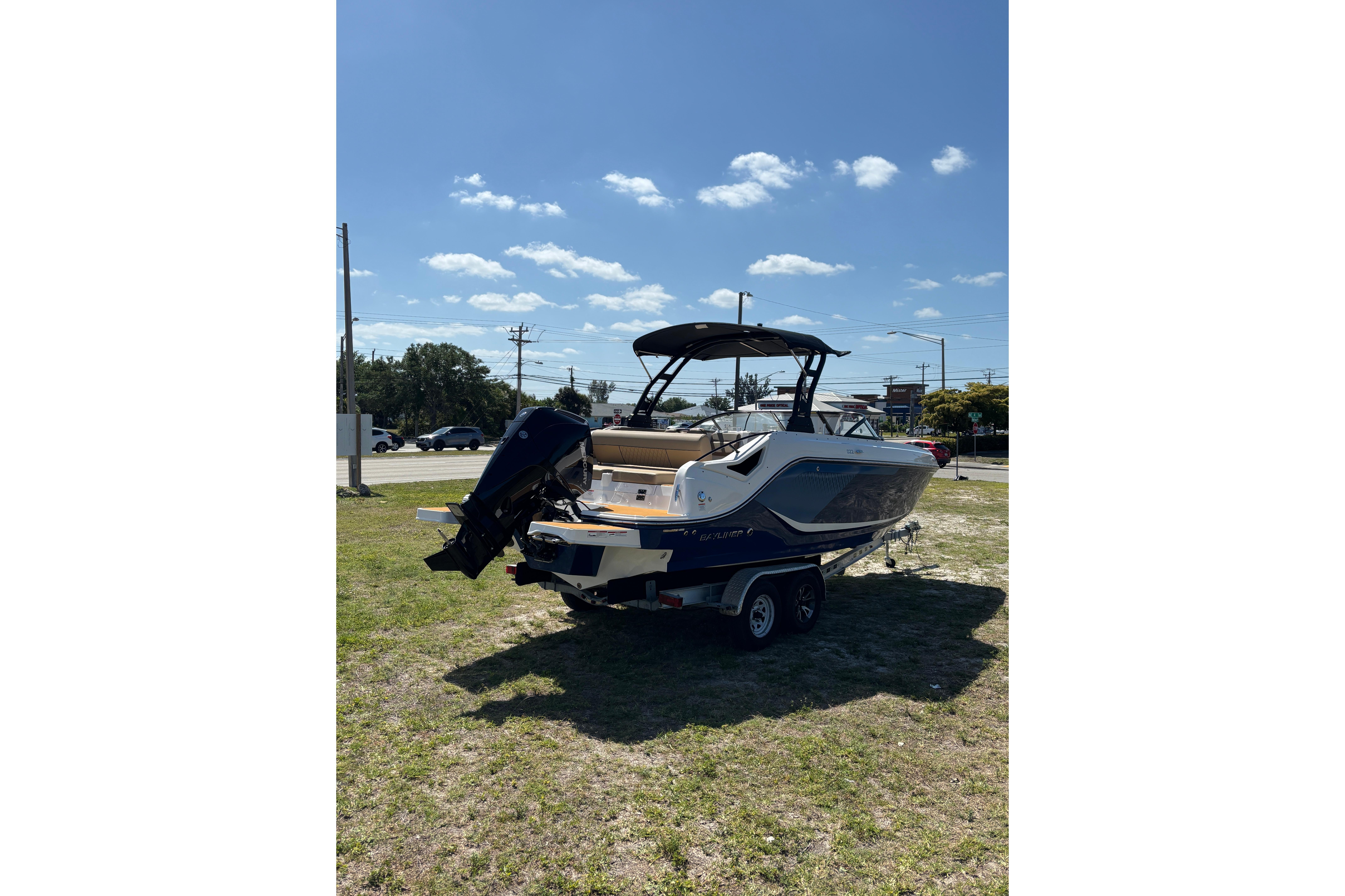 2026 Bayliner D22 boat on trailer under clear blue sky.