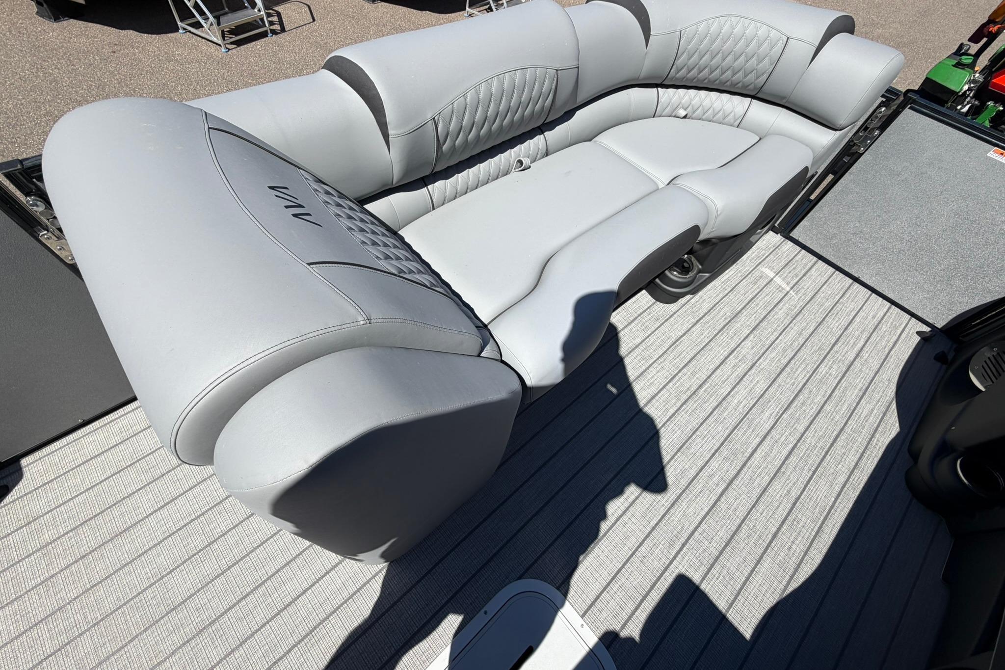 Luxurious seating on 2026 Avalon Catalina Quad Lounge Shift pontoon boat, featuring elegant gray upholstery.