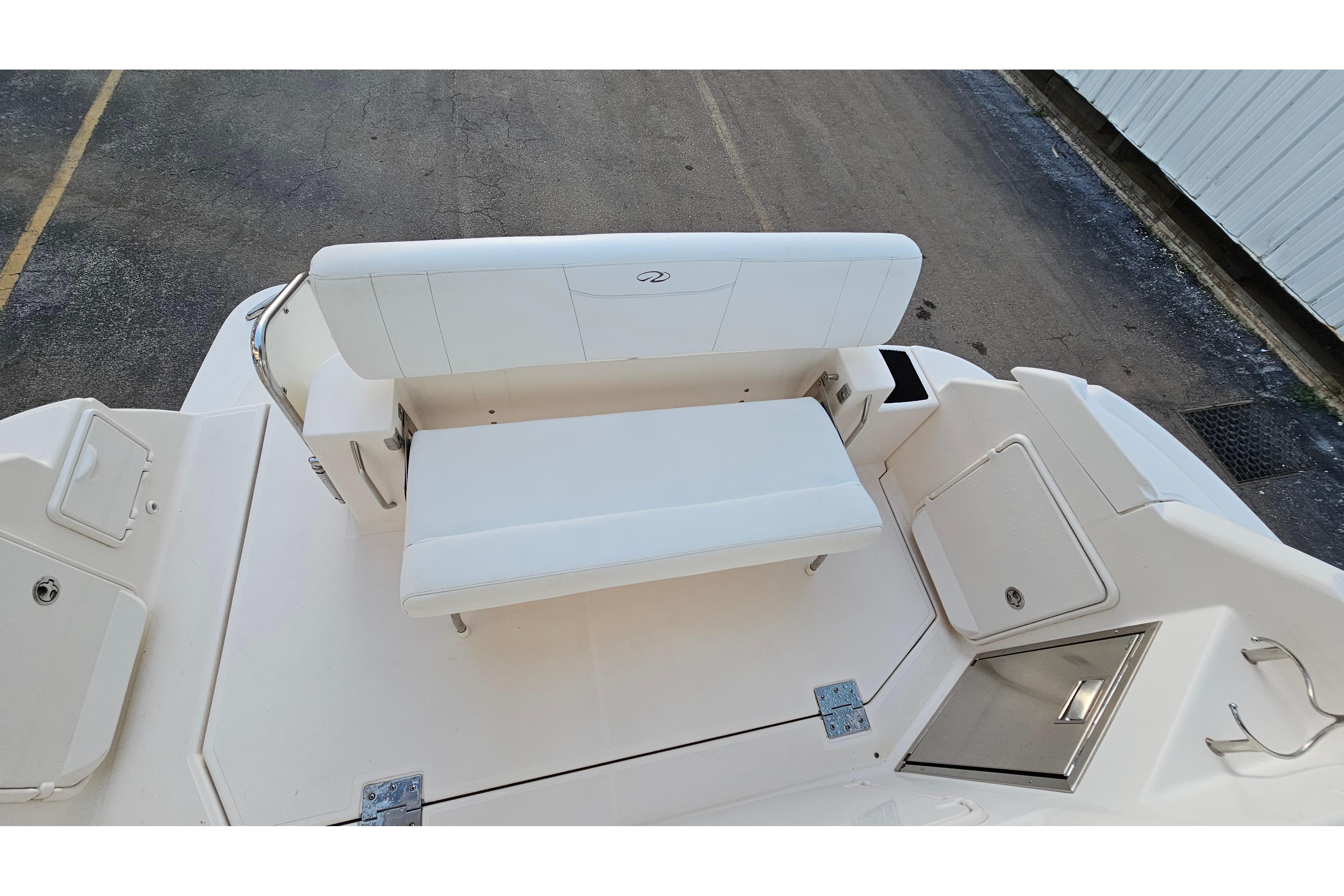 2005 Regal 3060 Window Express boat interior with white seating and storage compartments.
