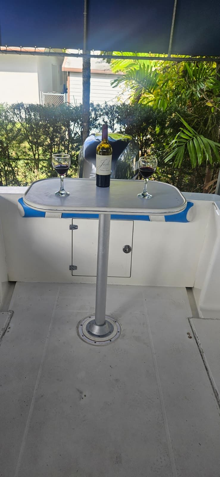 Wellcraft 24 Walkaround 2000 with wine glasses and bottle on table.