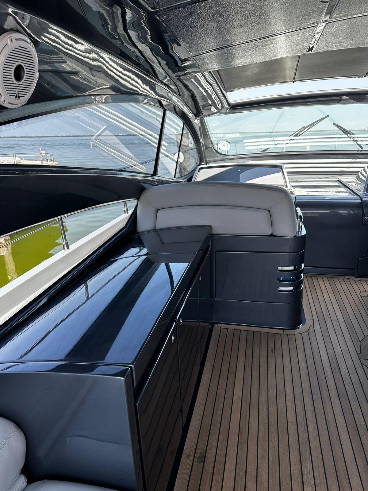 2009 Pershing 56 yacht interior with sleek design and wooden flooring.