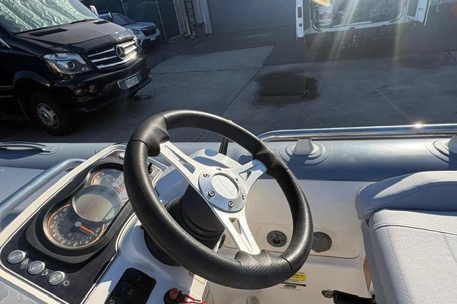 Steering wheel of a 2018 Williams 345 Sports Jet boat, with dashboard controls visible.