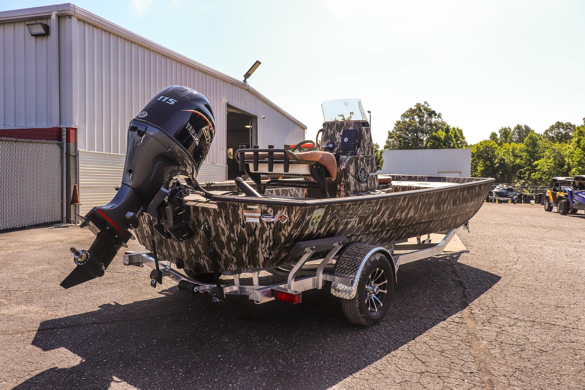 An Avid 20 Rogue CC boat from 2027 on a trailer outside a building.