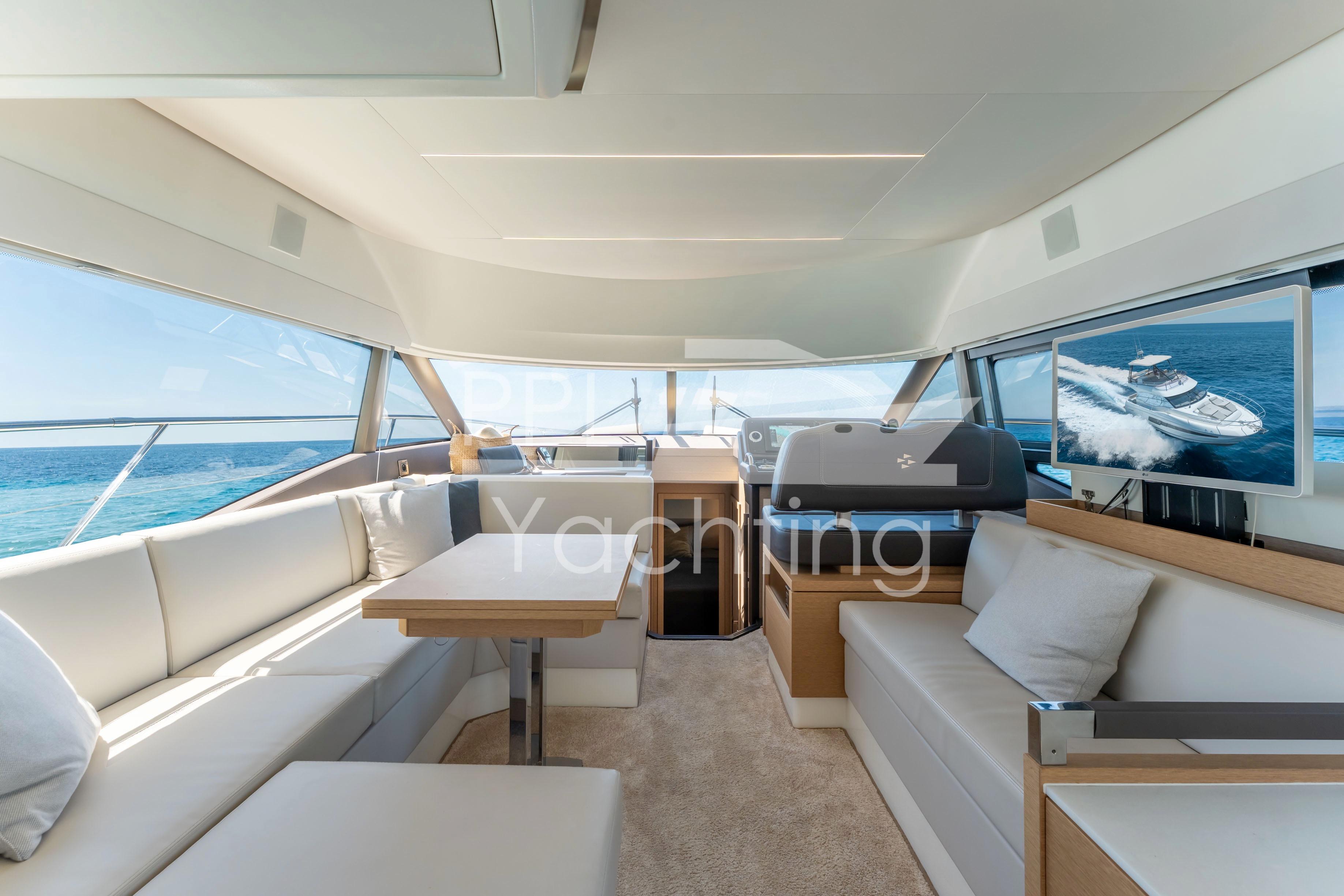 Luxurious interior of 2019 Prestige 460 yacht with elegant seating and ocean view.