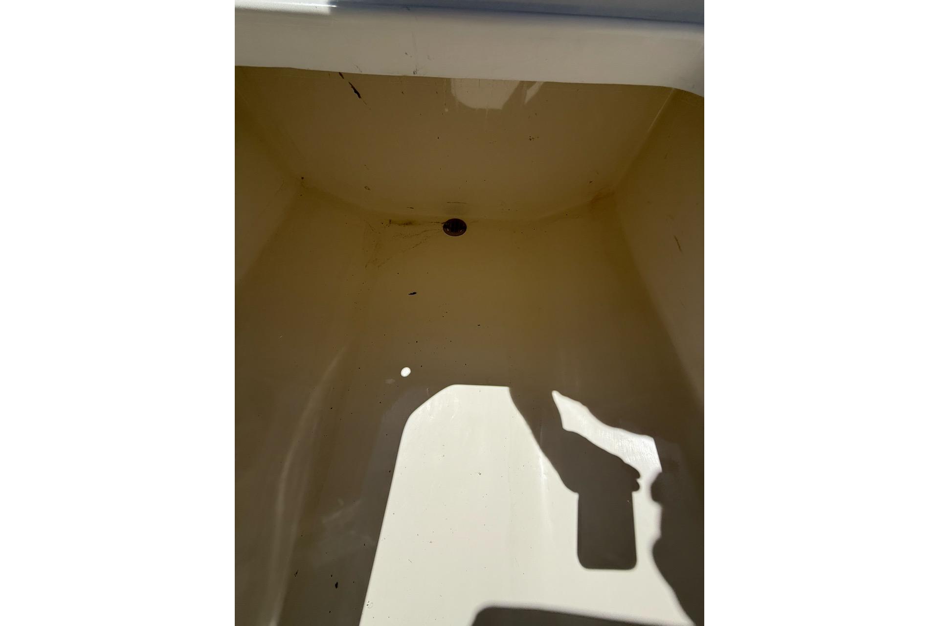 Empty storage compartment of 2021 Custom Infusion 34 CC boat.